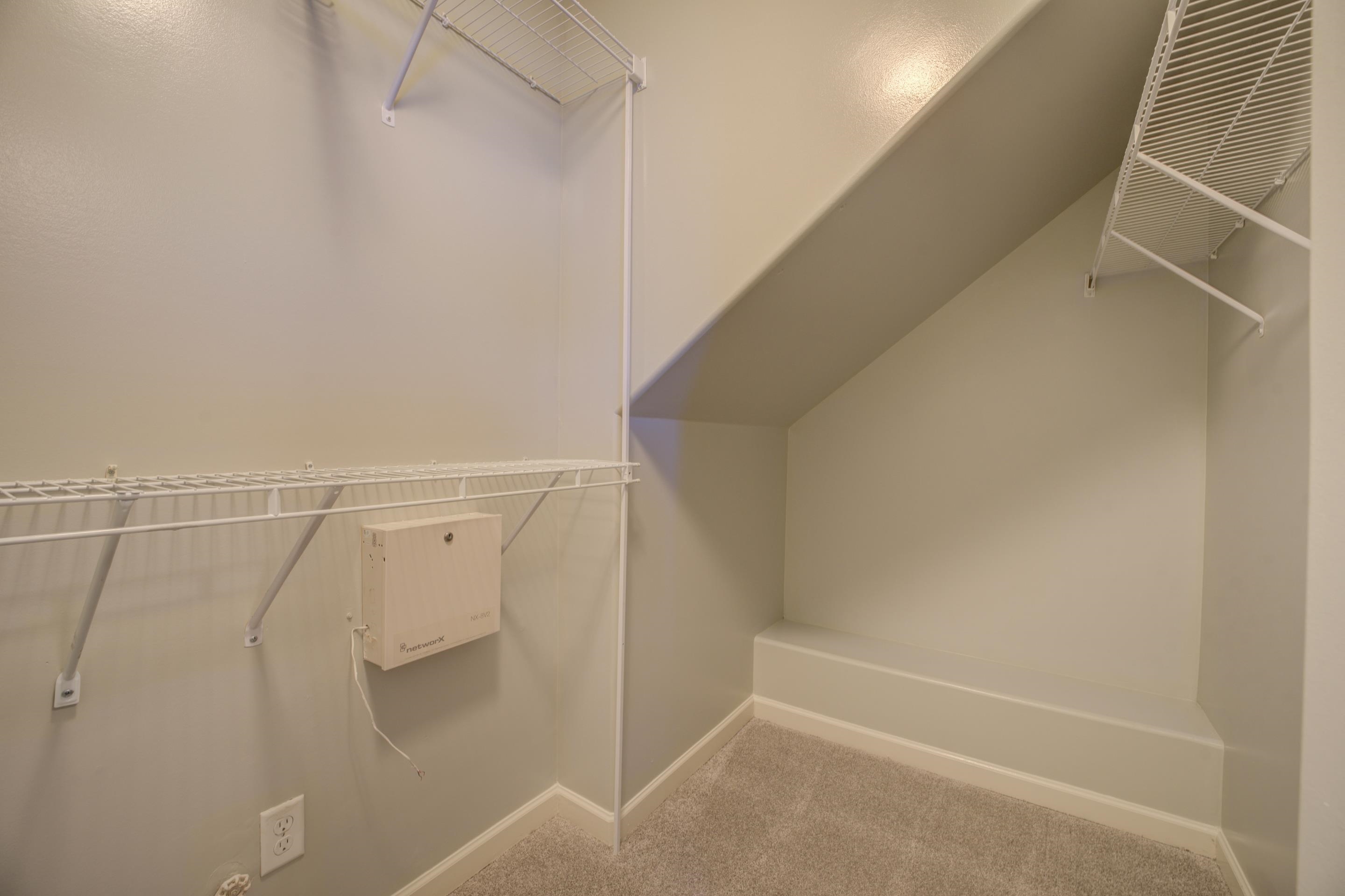 Spacious closet featuring lofted ceiling and carpet flooring