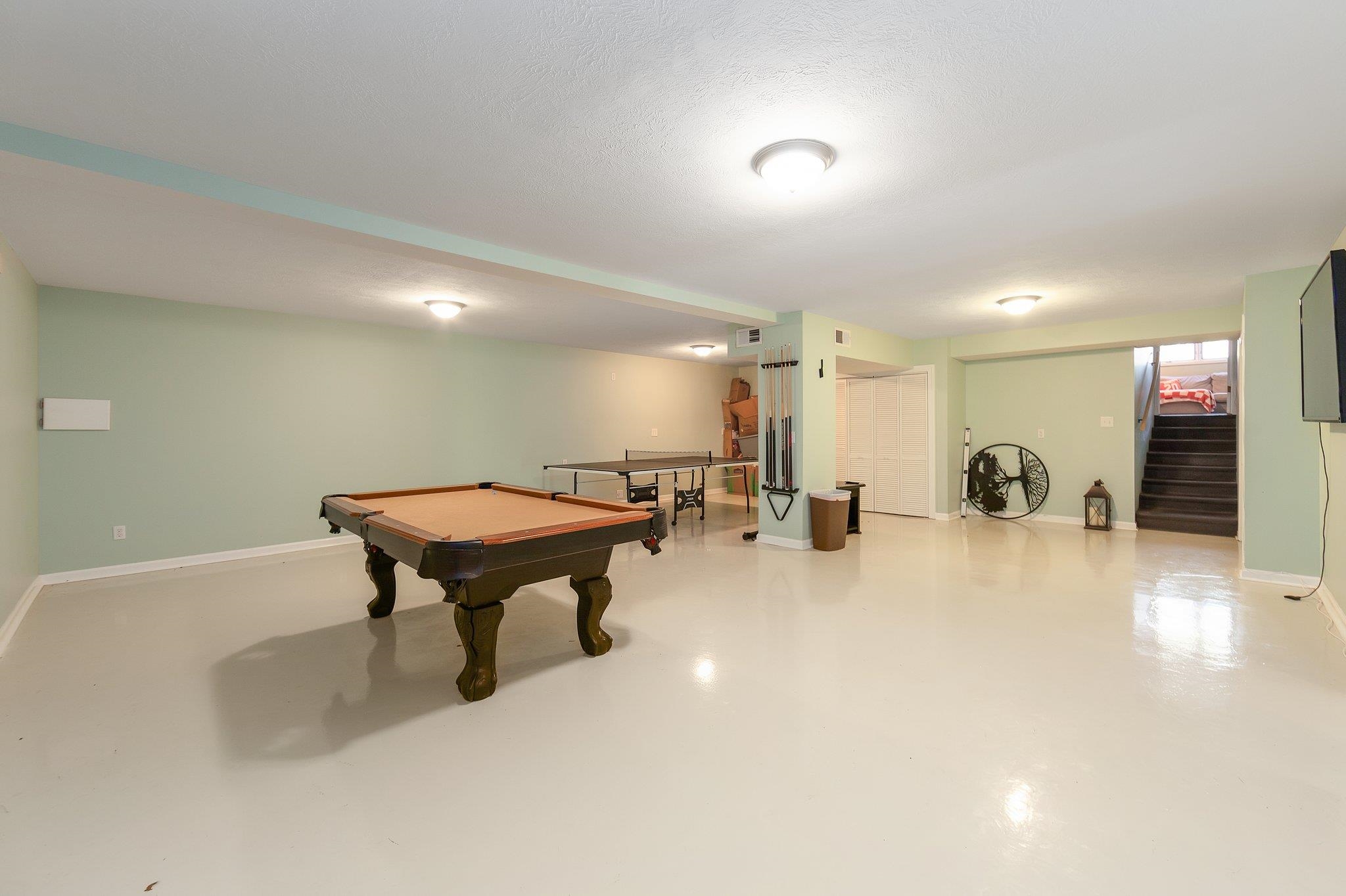 Rec room featuring concrete flooring, a textured ceiling, and pool table