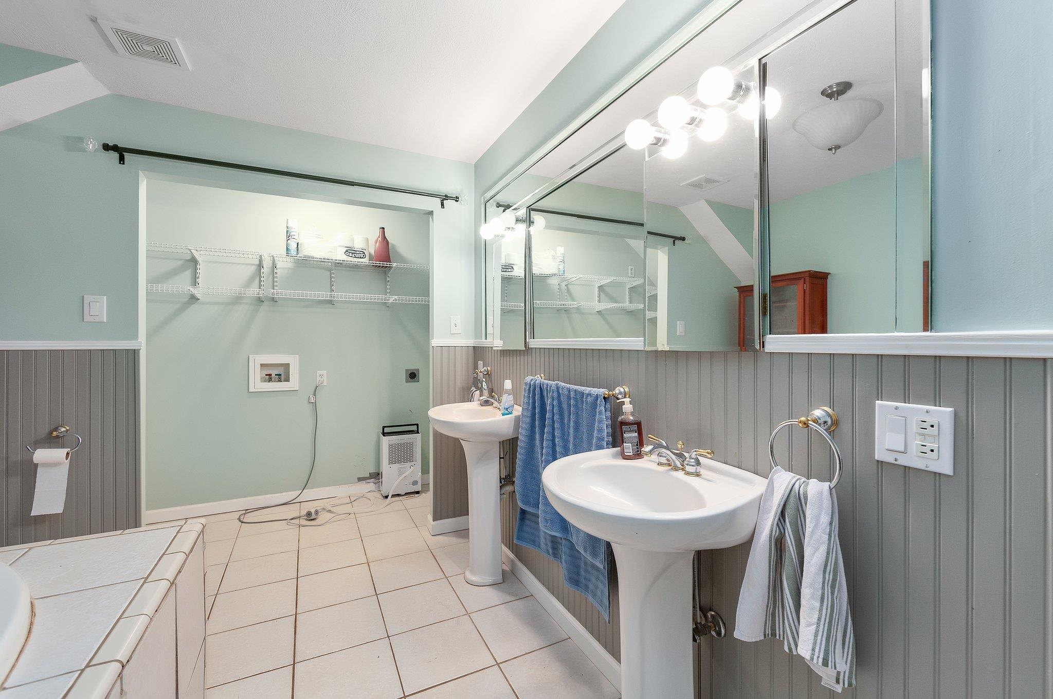 Bathroom with sink and tile patterned floors