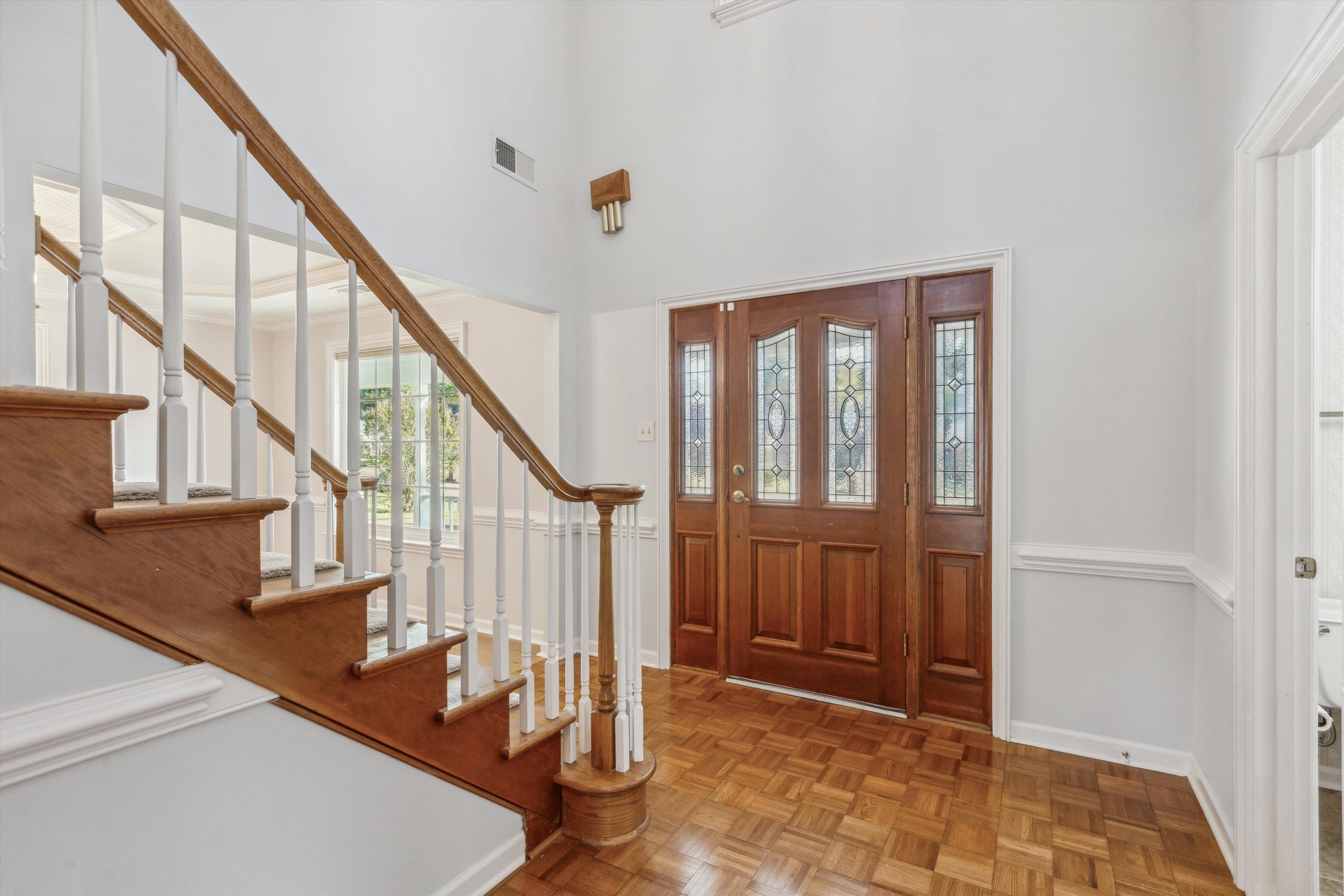 Foyer featuring a high ceiling and light parquet floors