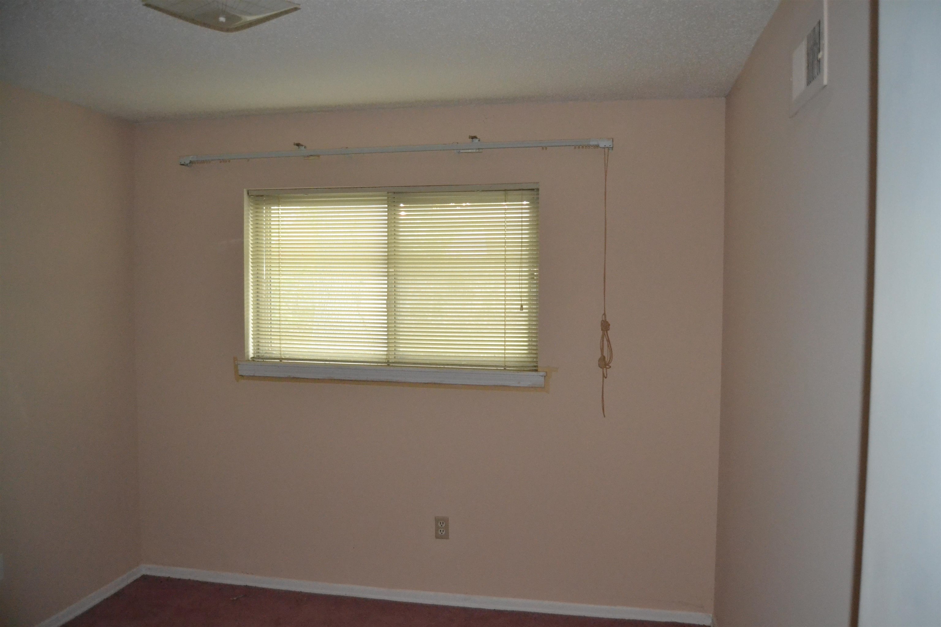 Unfurnished room featuring a textured ceiling