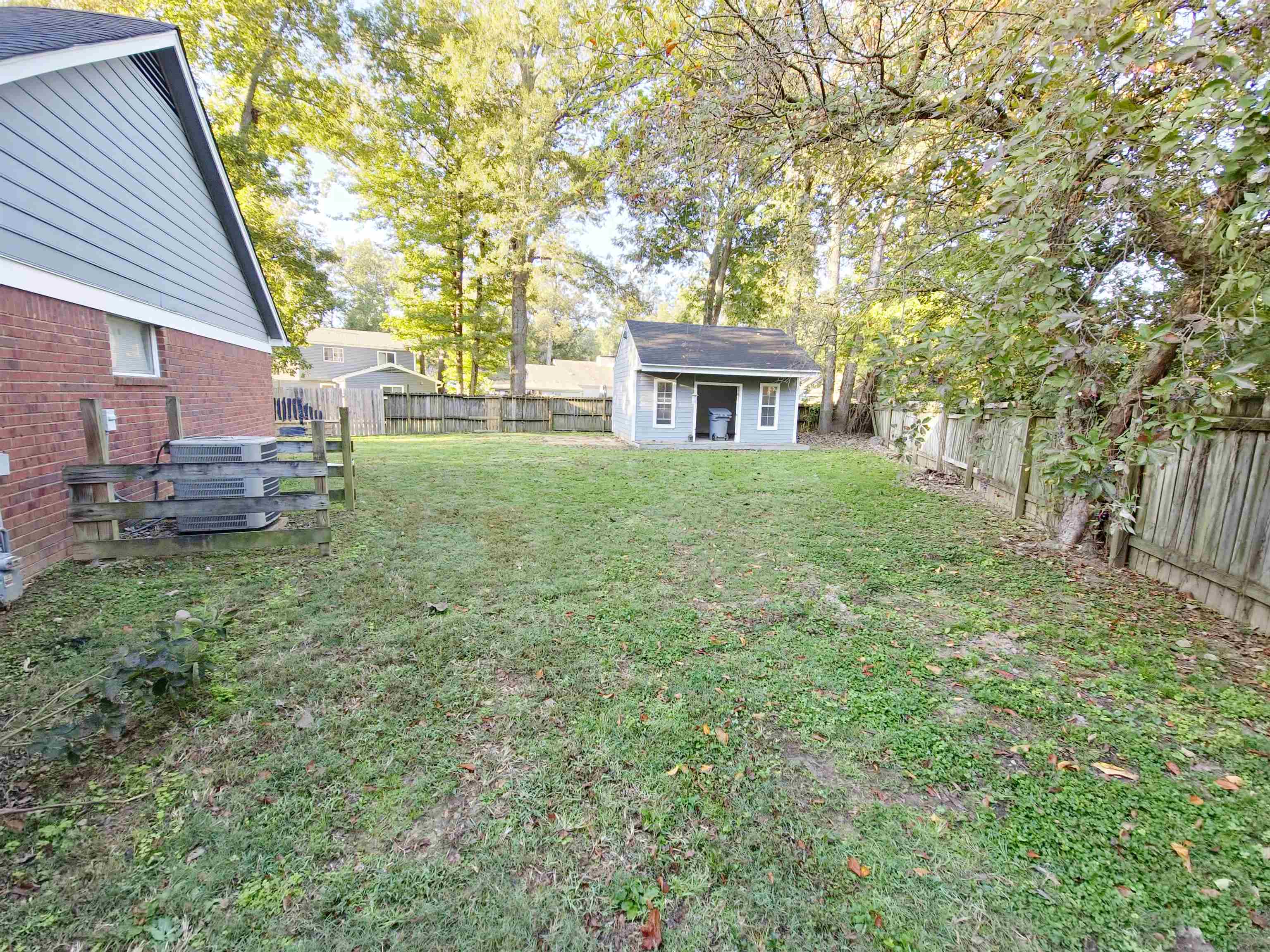 View of yard featuring a storage unit