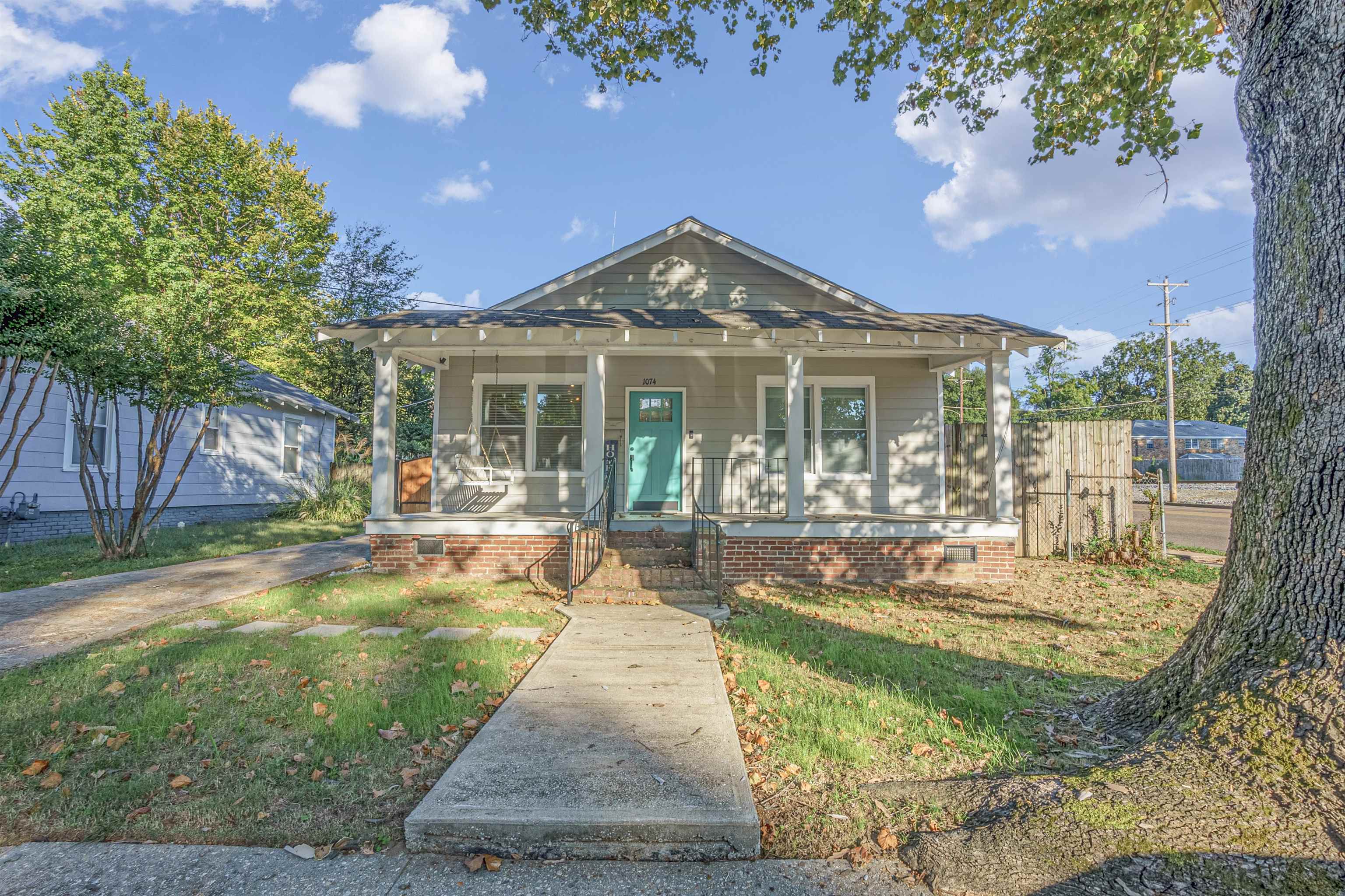 Bungalow-style house with a front lawn and covered porch