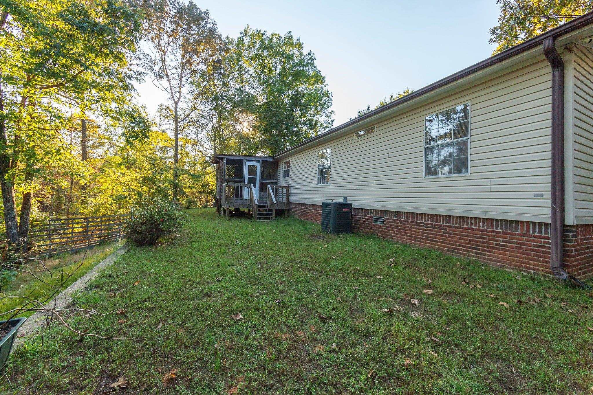 View of yard with central AC and a wooden deck