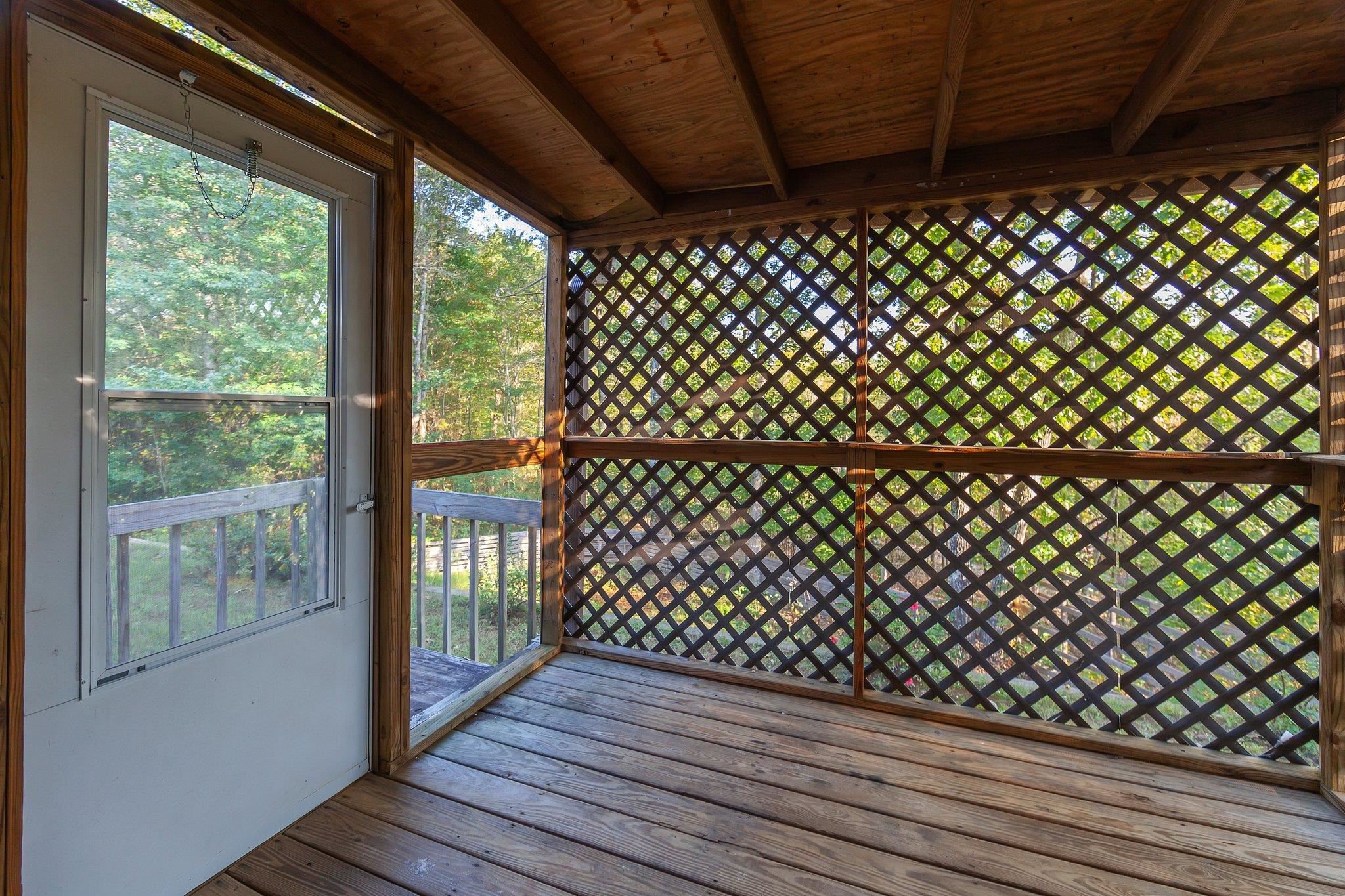 Unfurnished sunroom with wooden ceiling