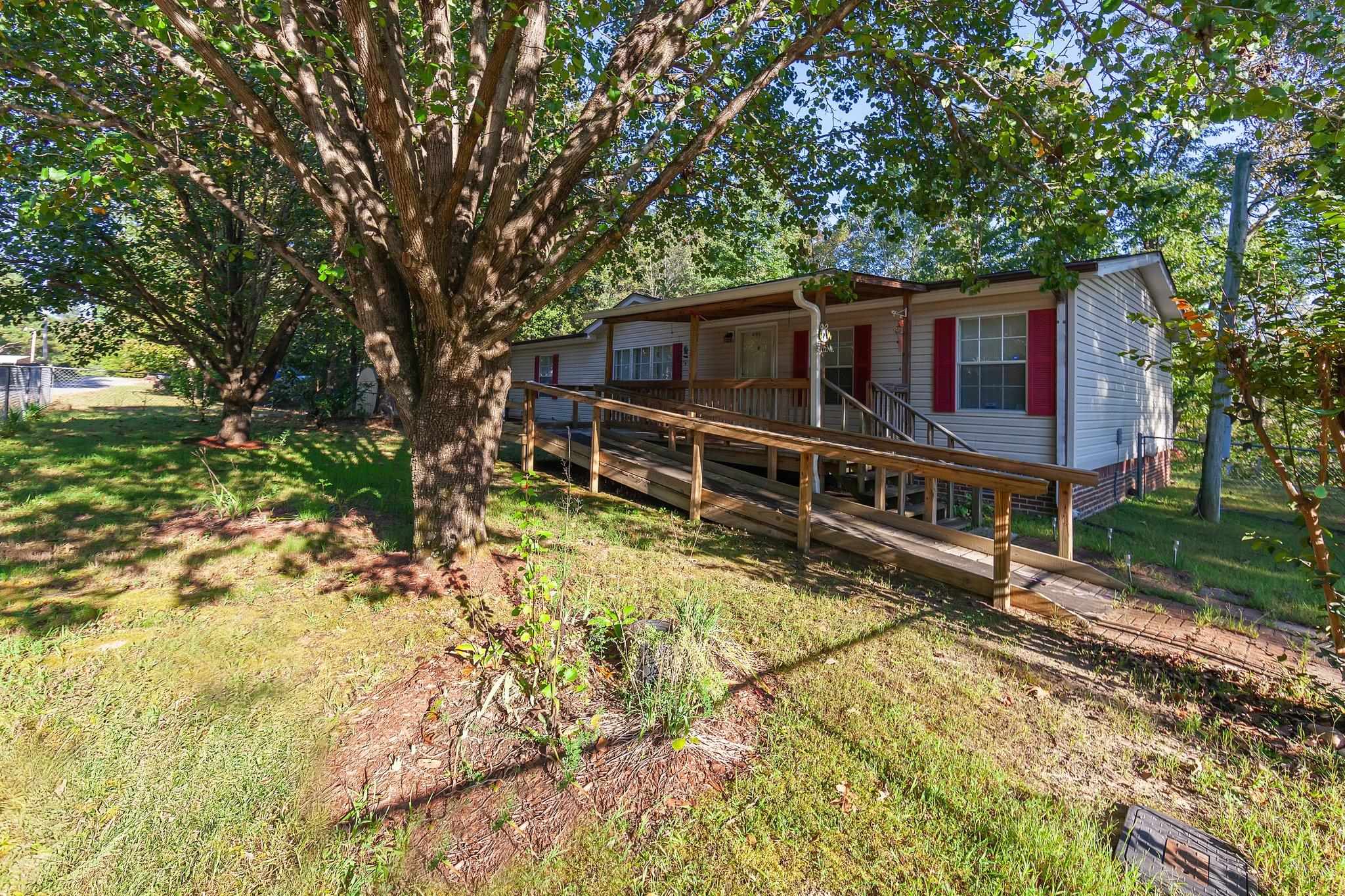 Exterior space with a deck and a front yard