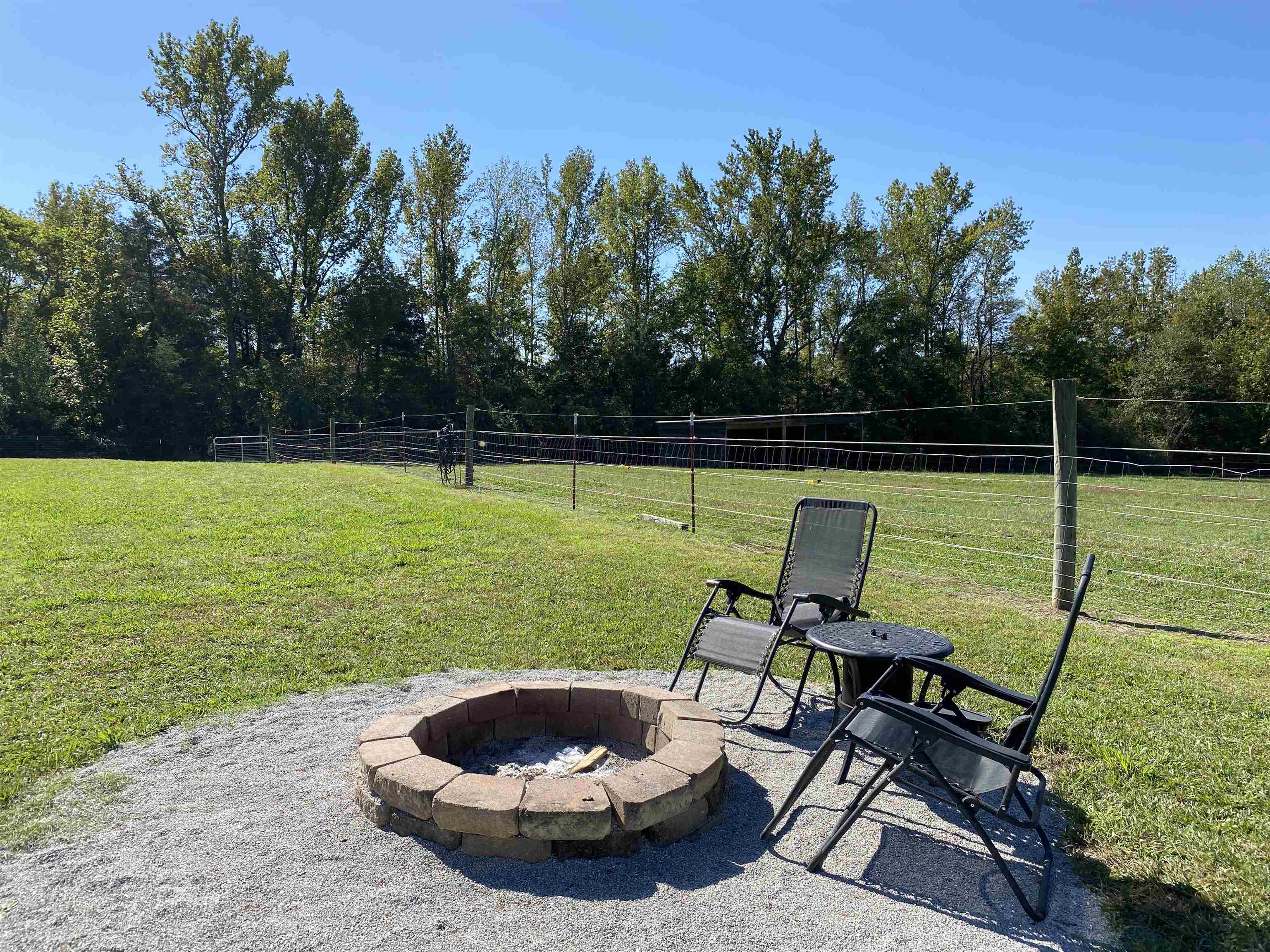 View of yard with a patio and an outdoor fire pit