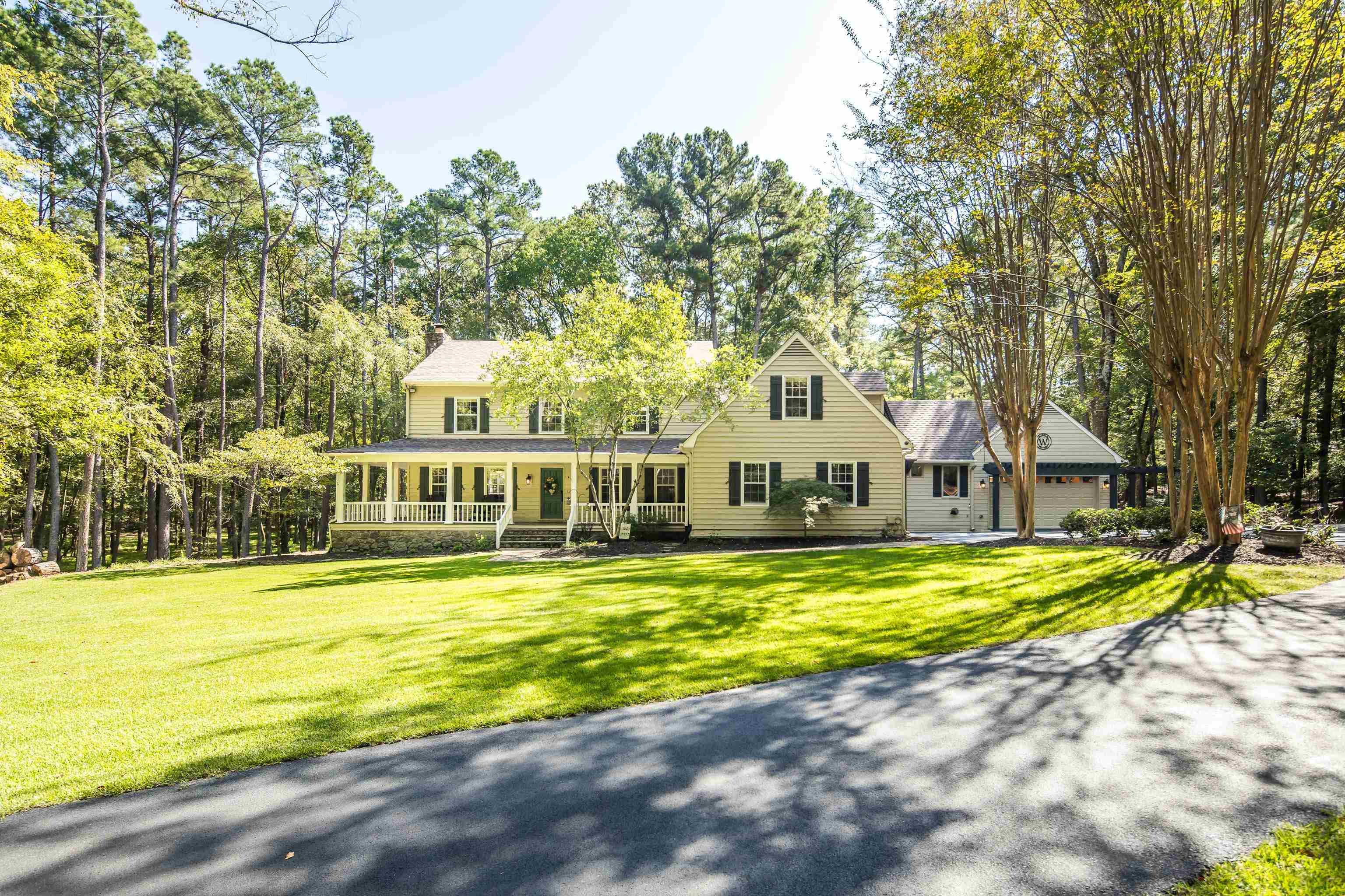 View of front of house with a front lawn and covered porch