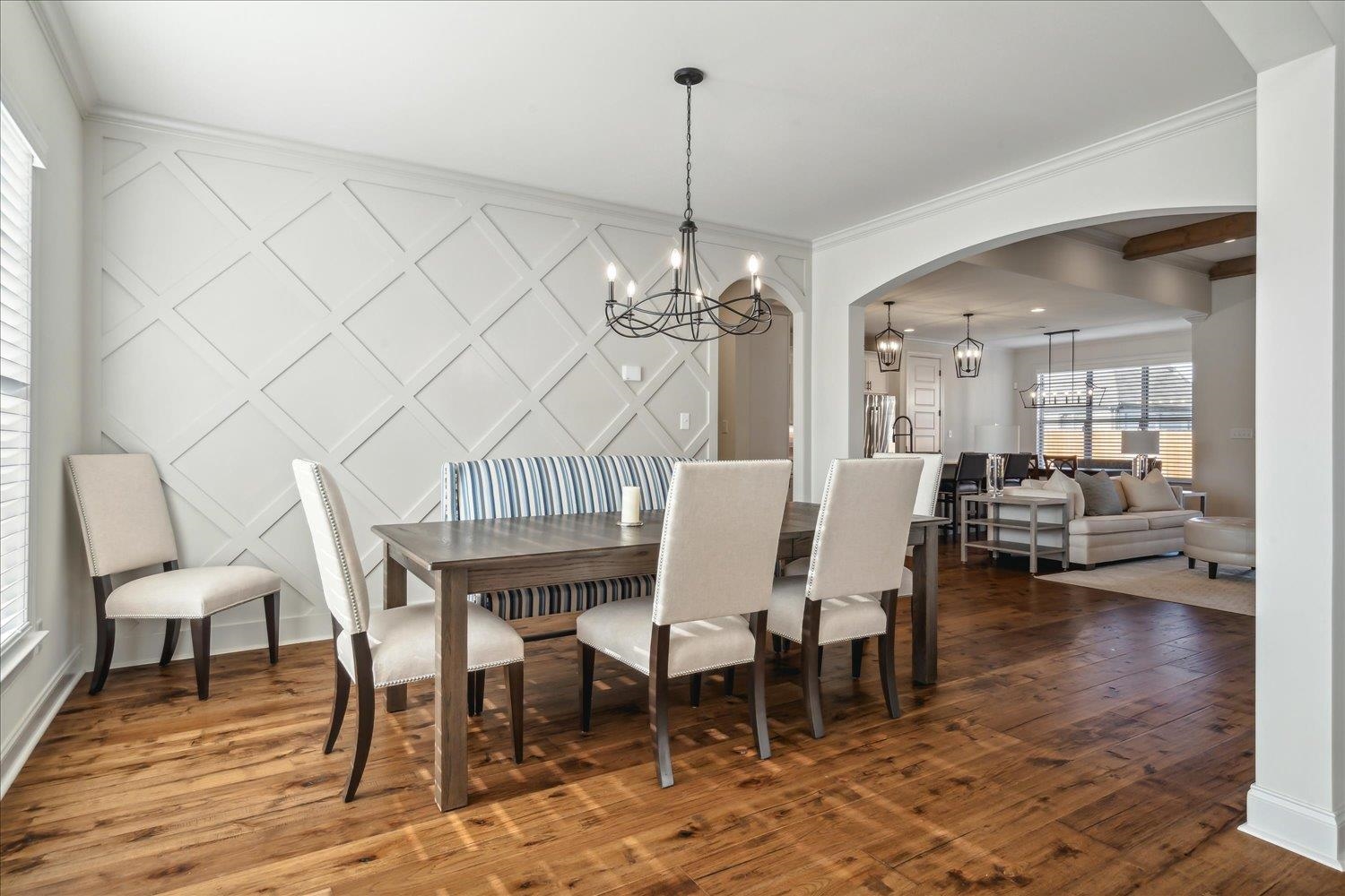 Dining area featuring ornamental molding, a chandelier, and dark wood-type flooring