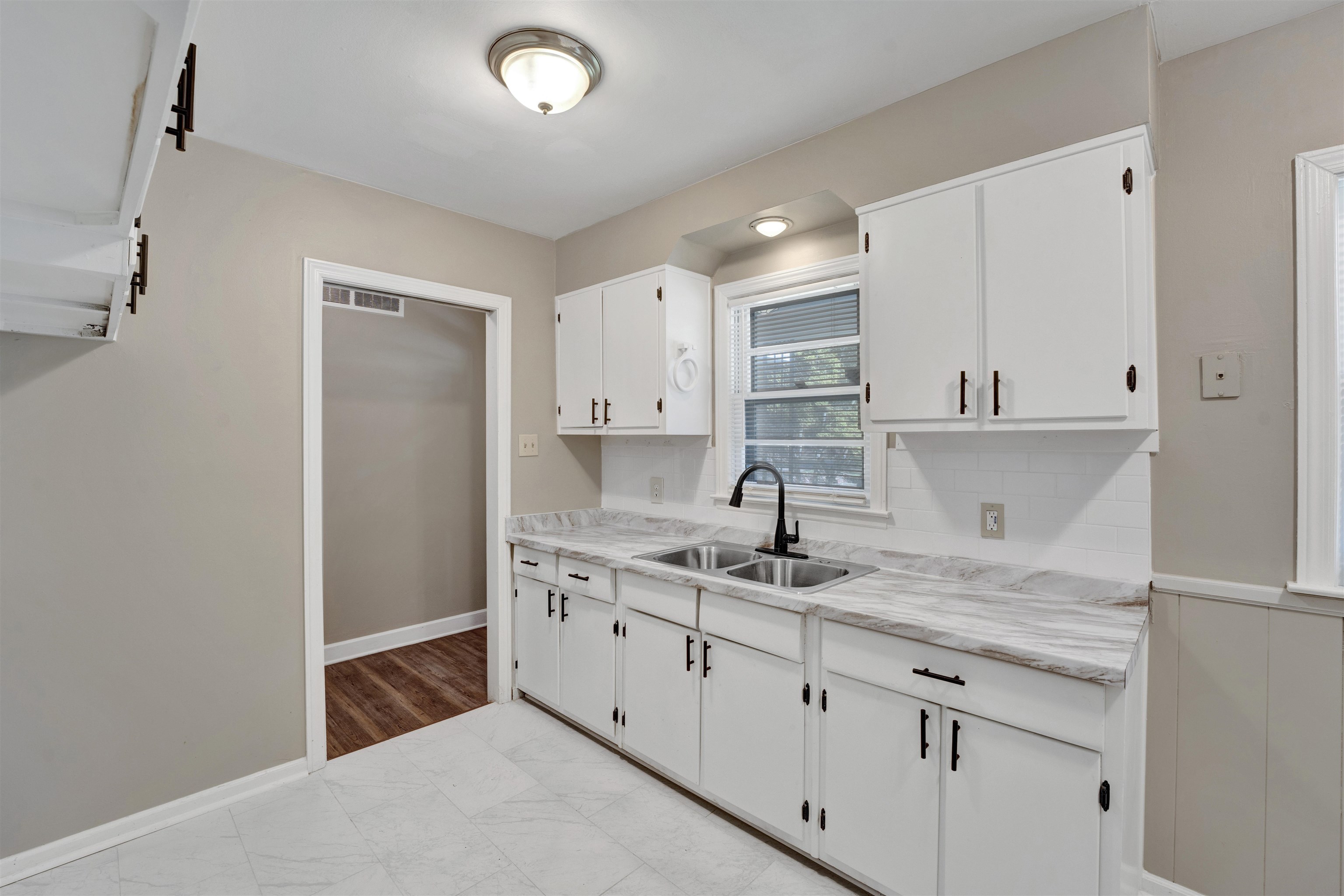 Kitchen with sink and white cabinetry