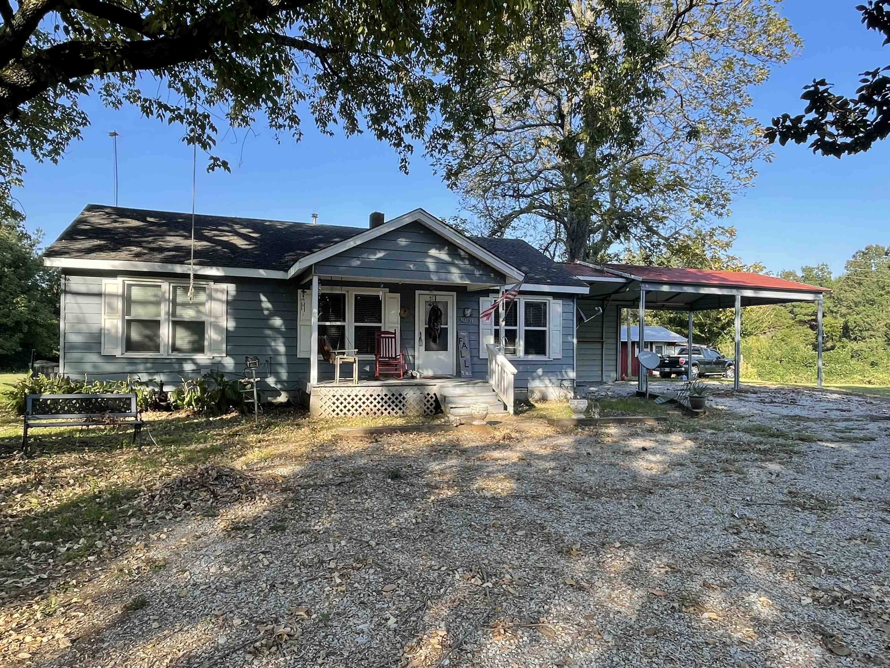 View of front of house with a carport and covered porch