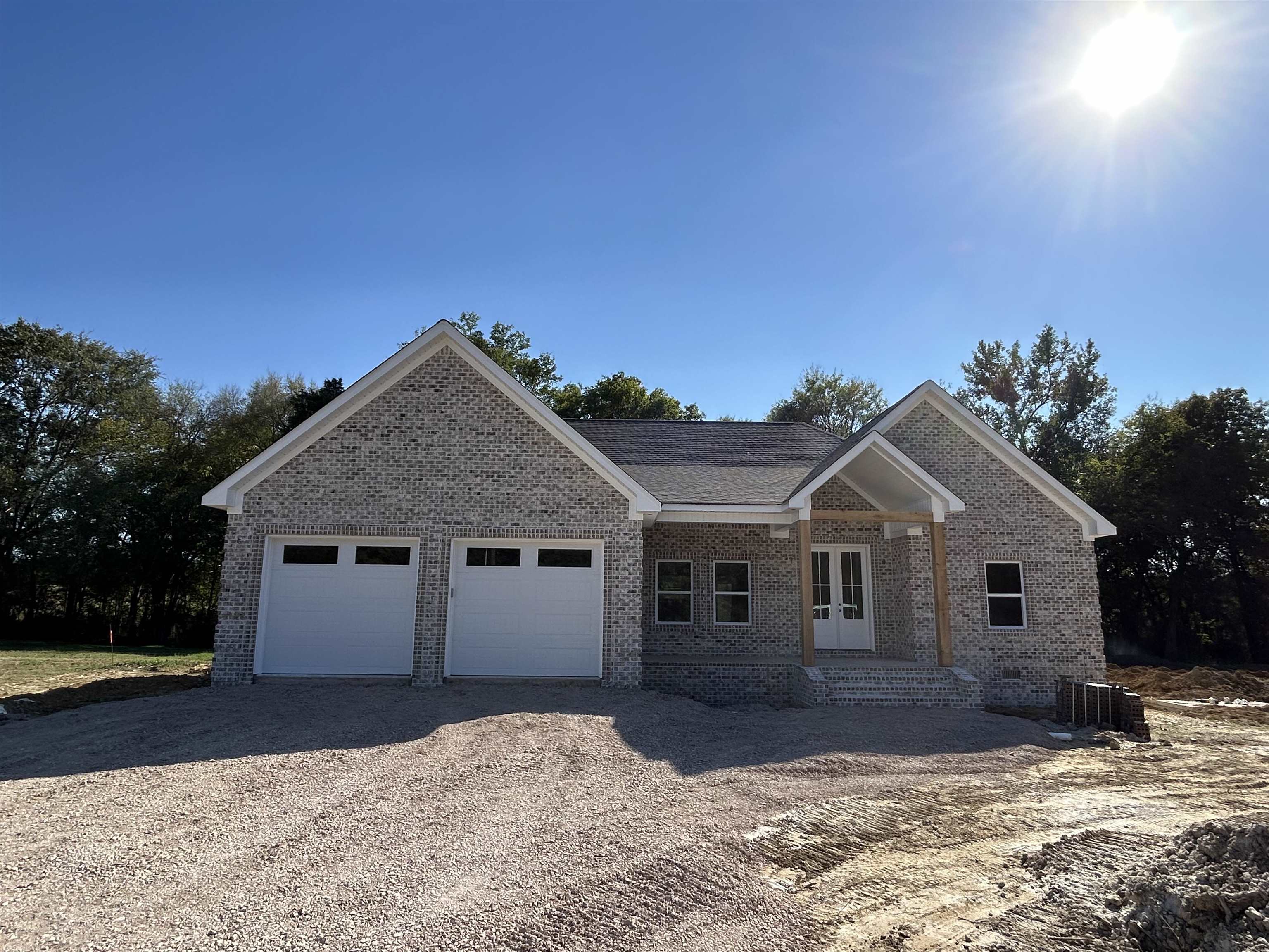 View of front of property featuring a porch and a garage