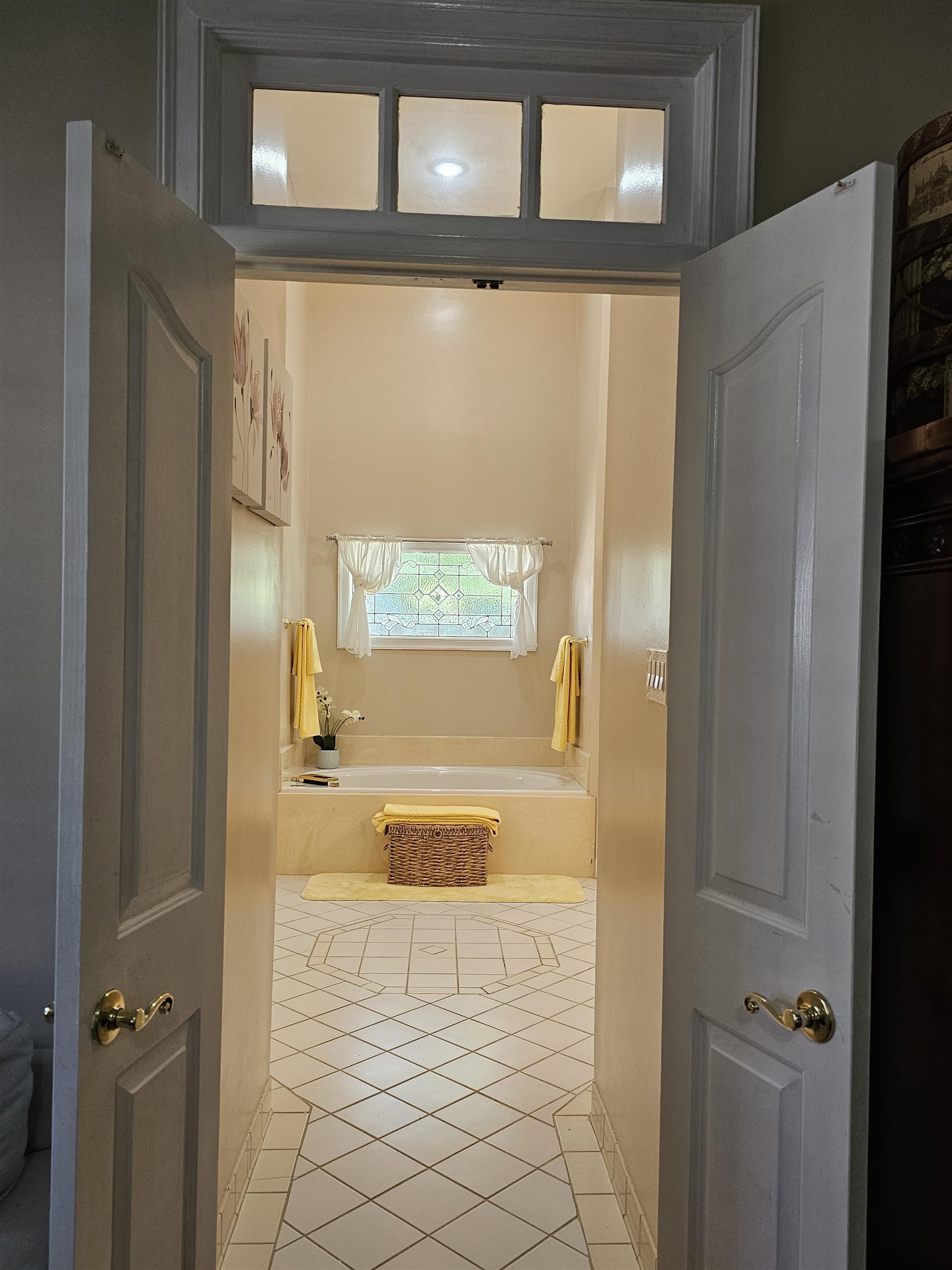 Bathroom featuring tile patterned flooring and tiled tub