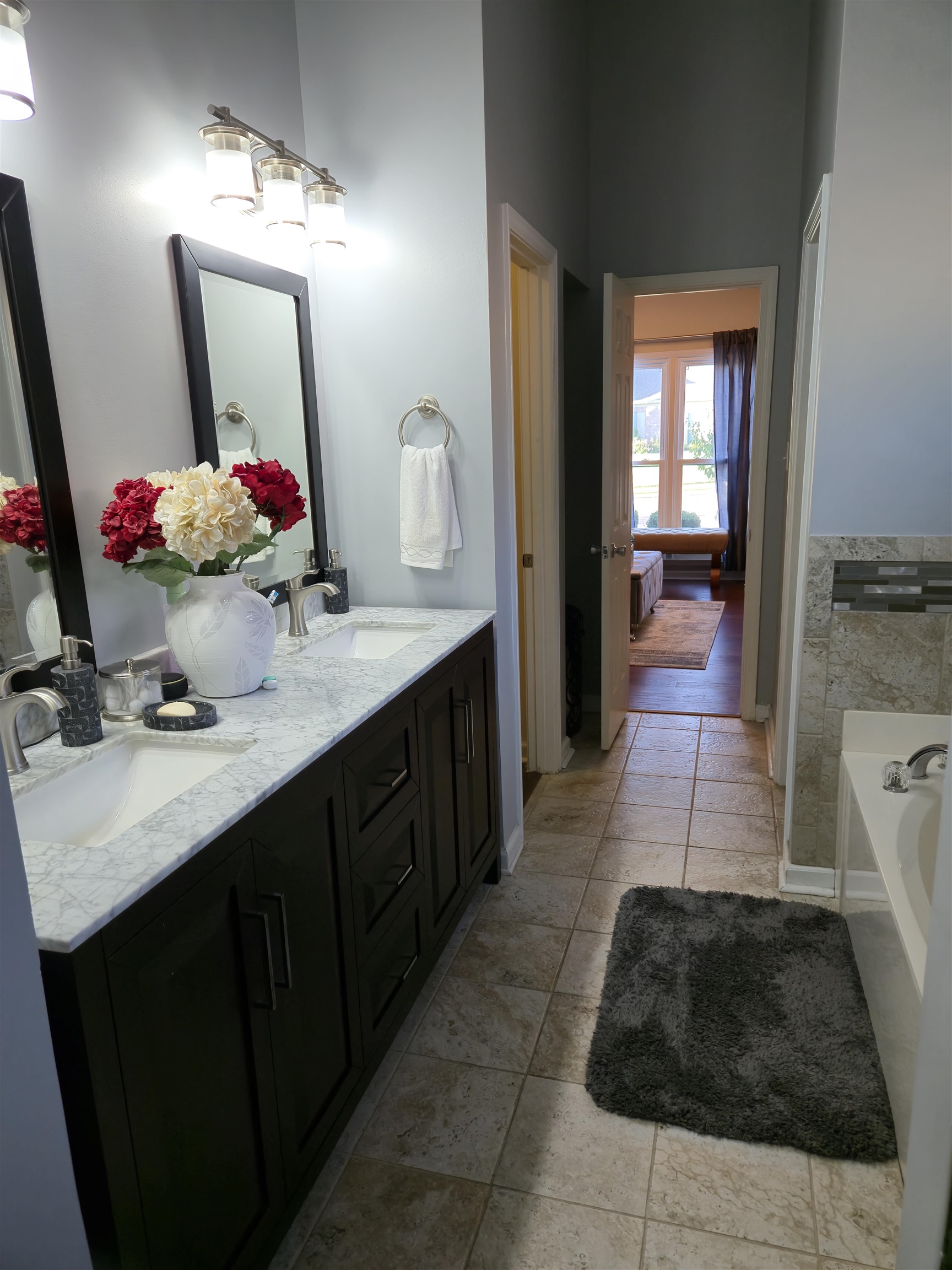 Bathroom with a washtub and vanity