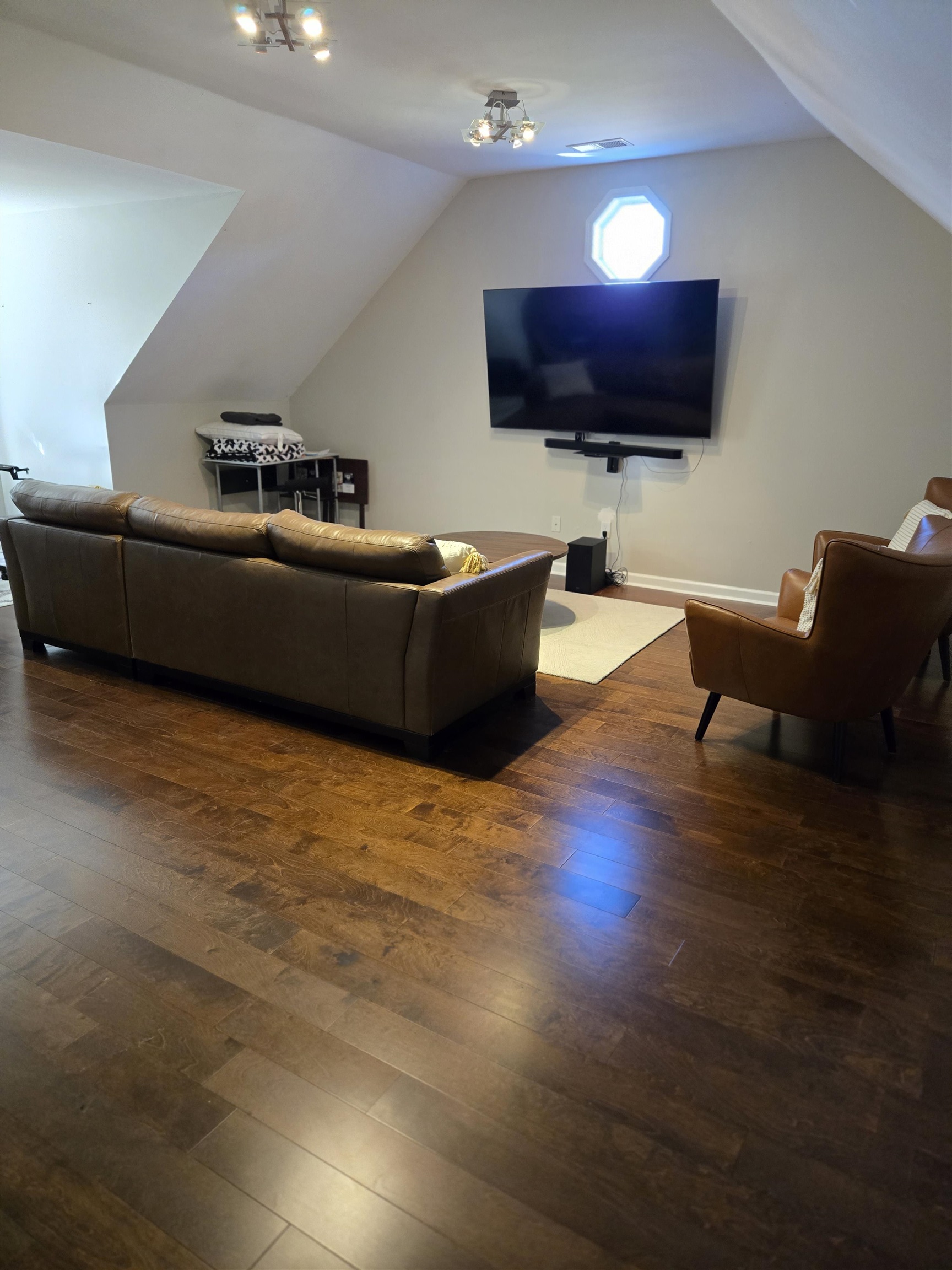 Living room with vaulted ceiling and dark hardwood / wood-style floors