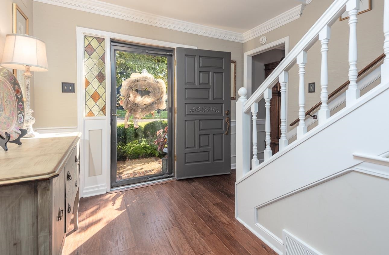 Interior entrance/foyer with engineered hardwood and molding/ smooth ceilings throughout