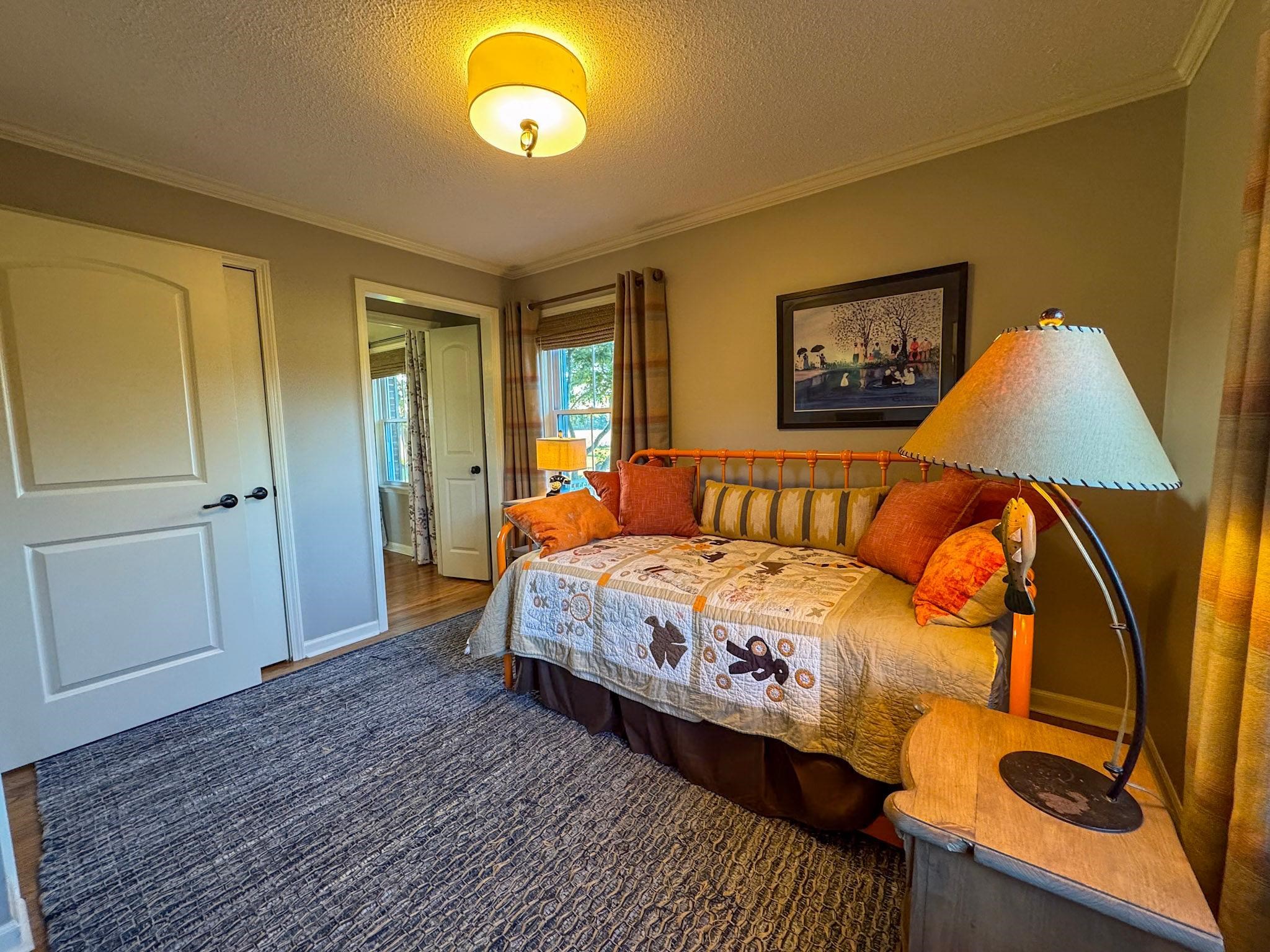 Bedroom featuring crown molding, a textured ceiling, and dark wood-type flooring