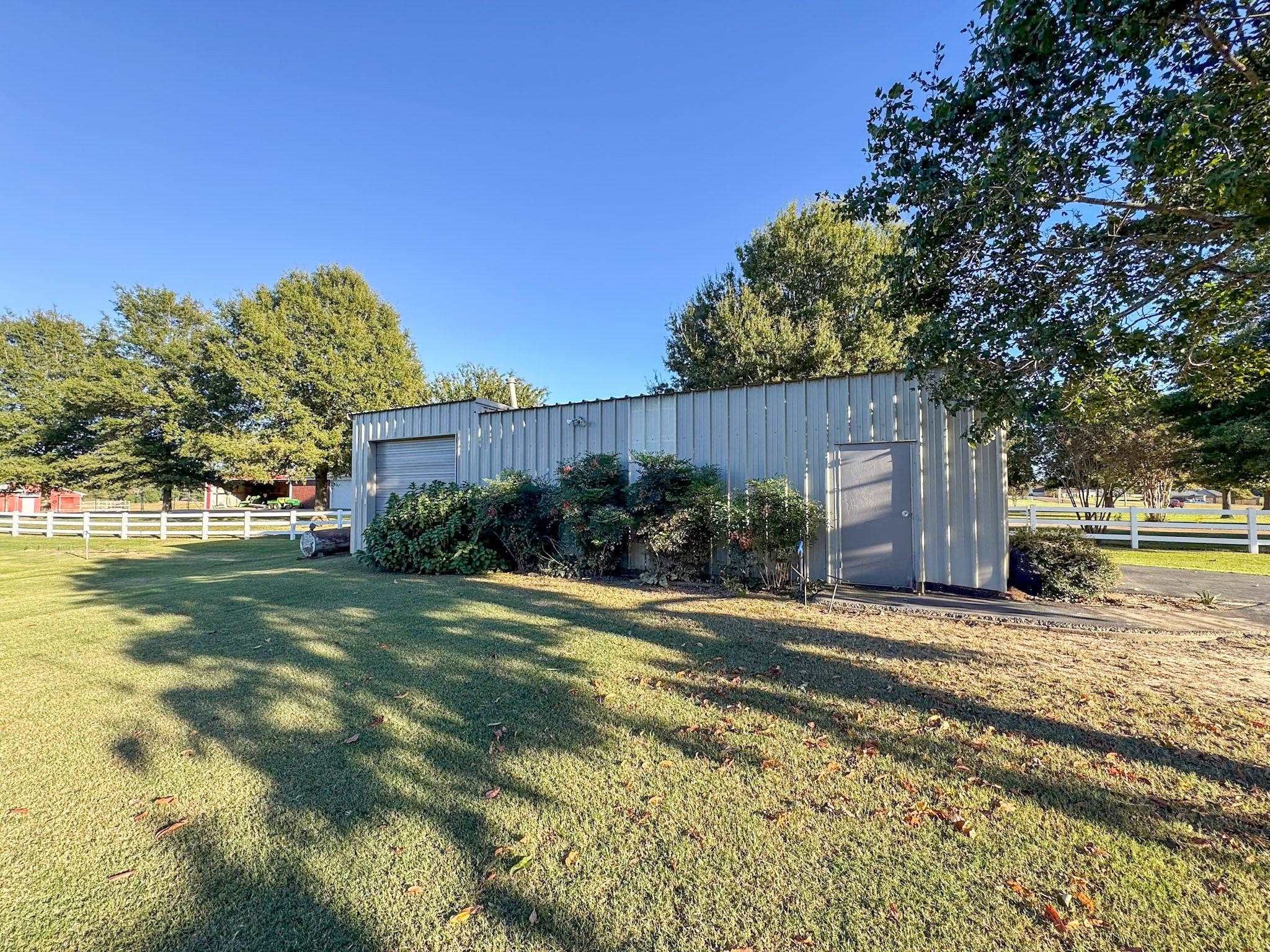 View of yard featuring an outdoor structure and a garage