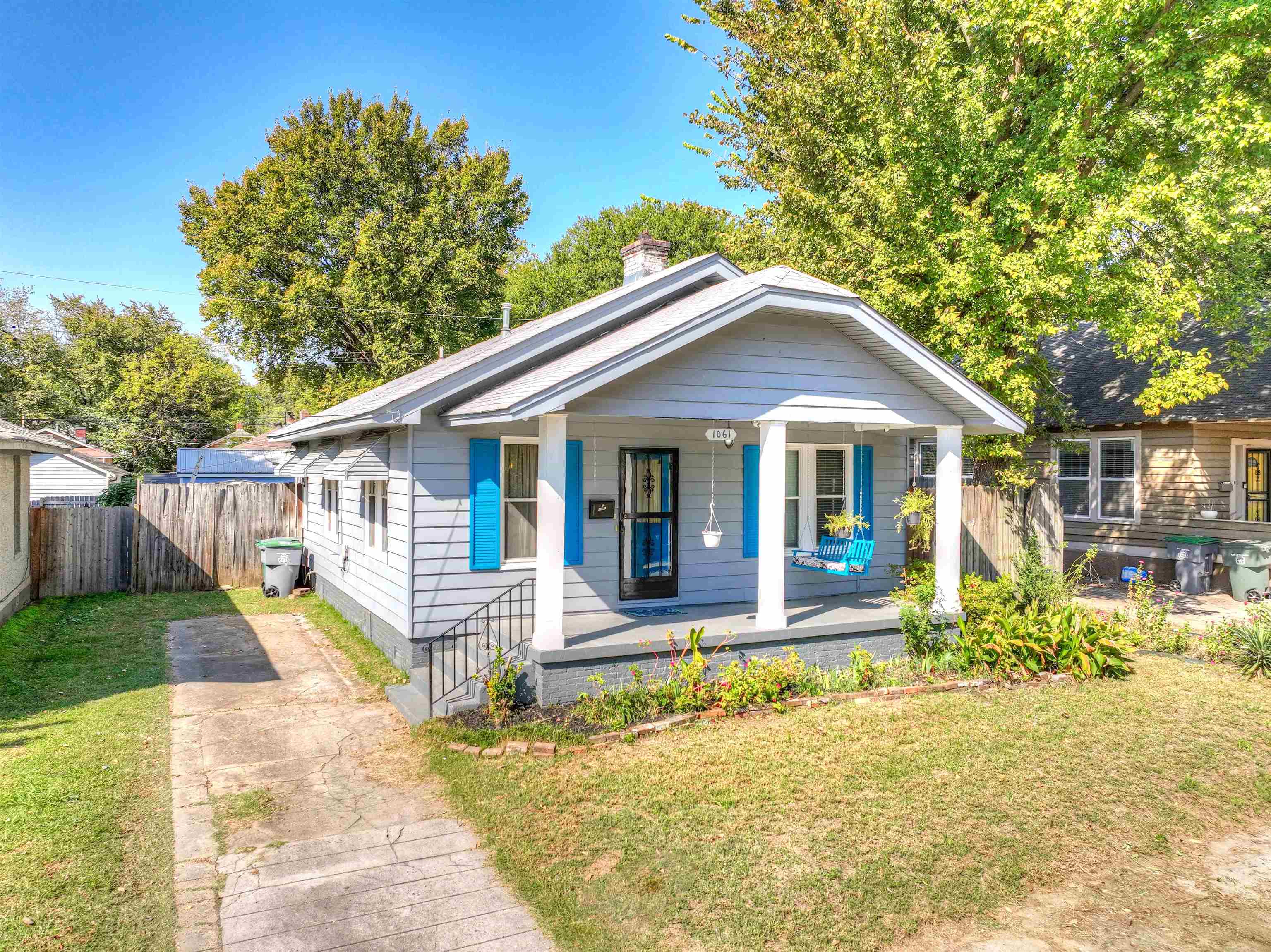 Bungalow-style home featuring a porch and a front lawn