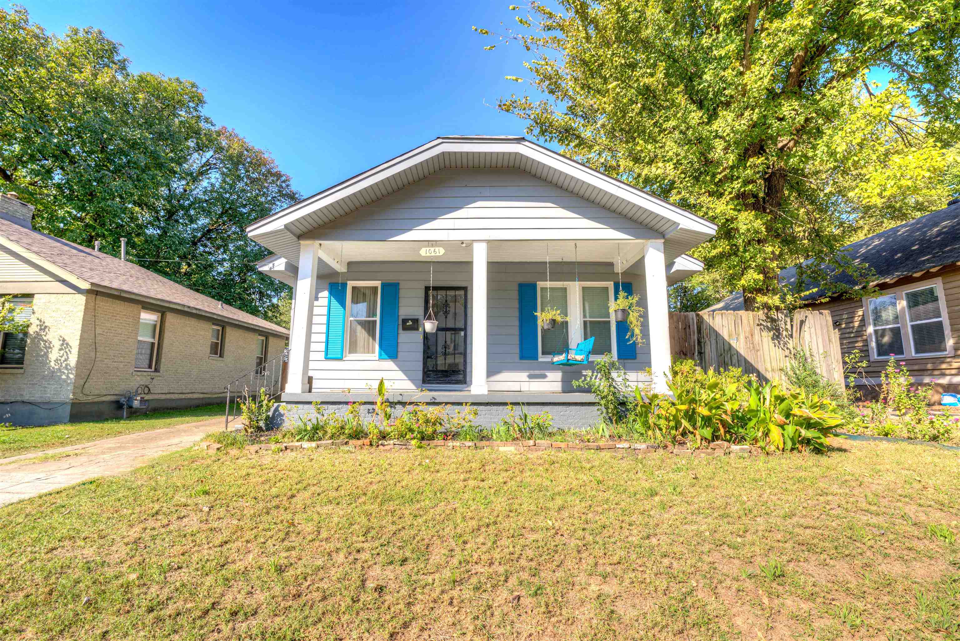 Bungalow-style house featuring a front yard and covered porch