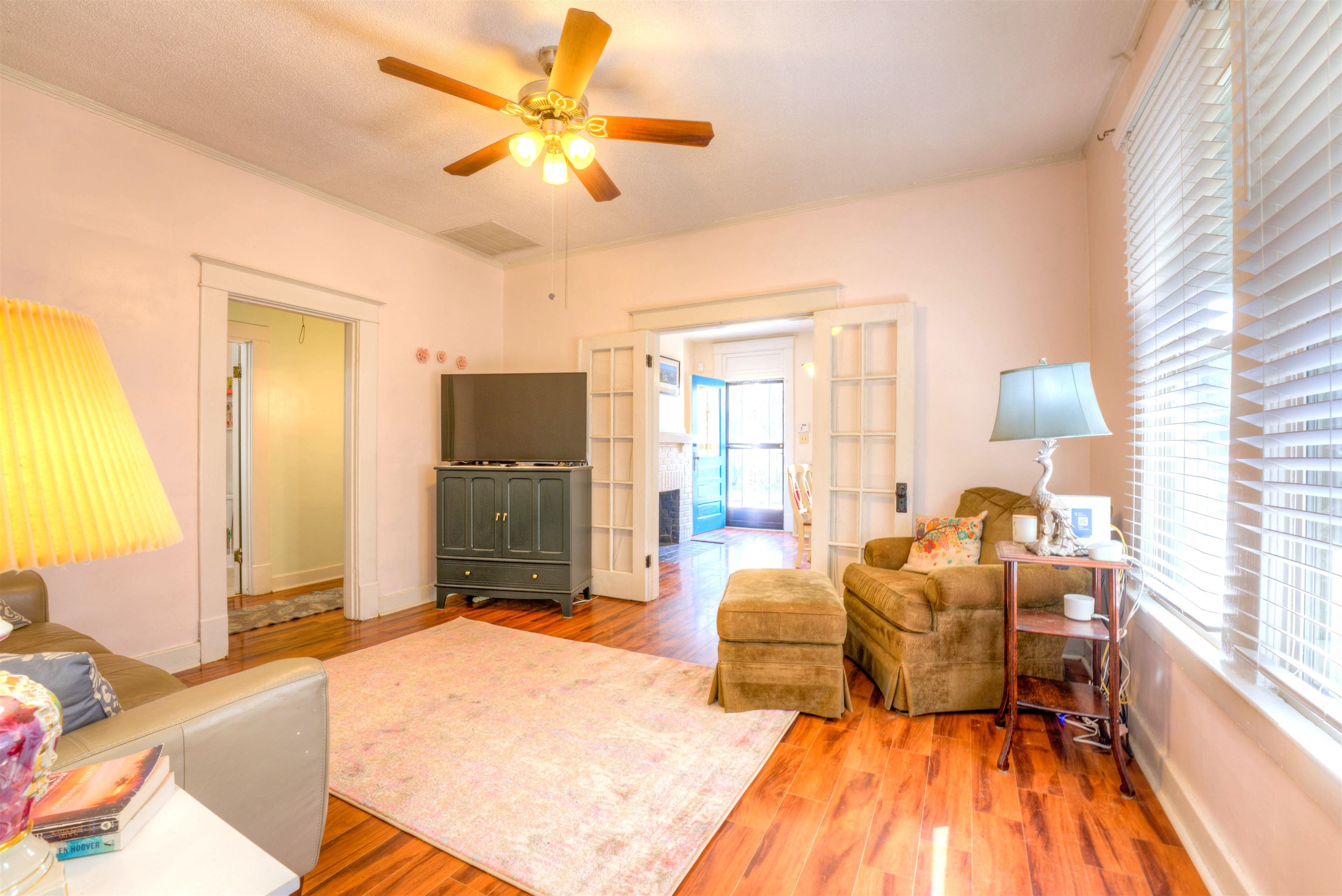 Living room featuring hardwood / wood-style flooring and ceiling fan