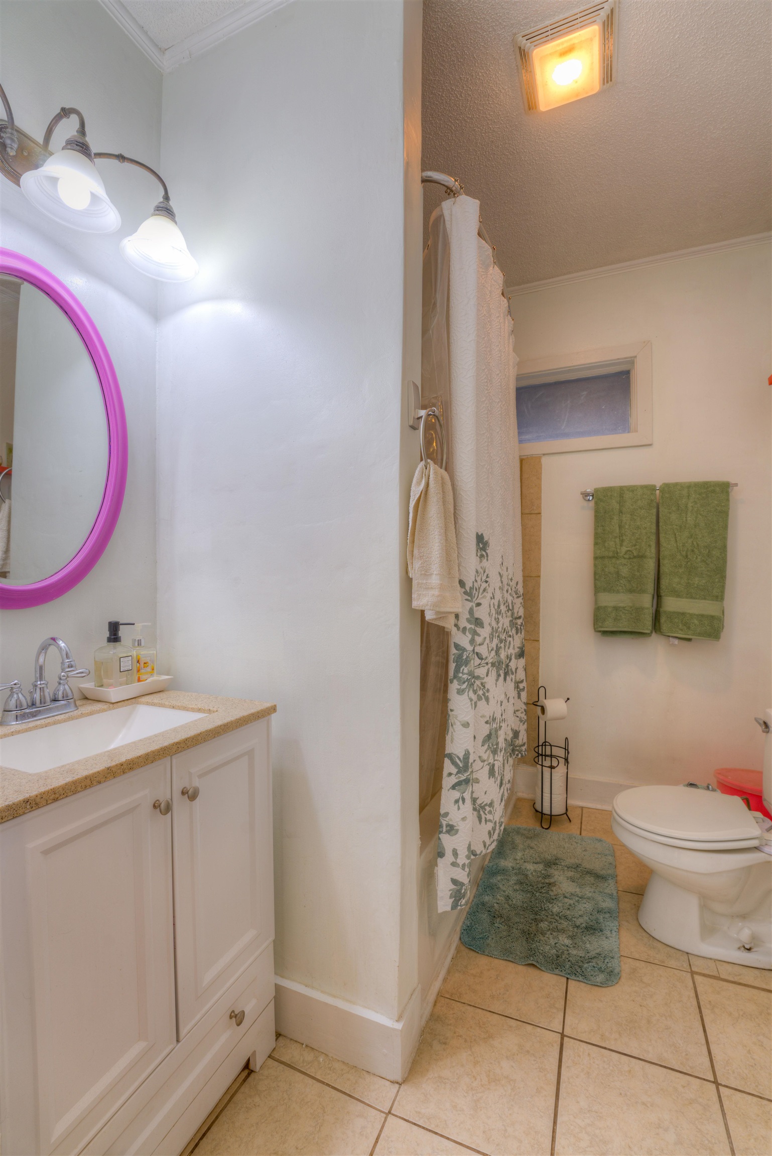 Full bathroom with shower / bath combination with curtain, vanity, toilet, a textured ceiling, and tile patterned flooring