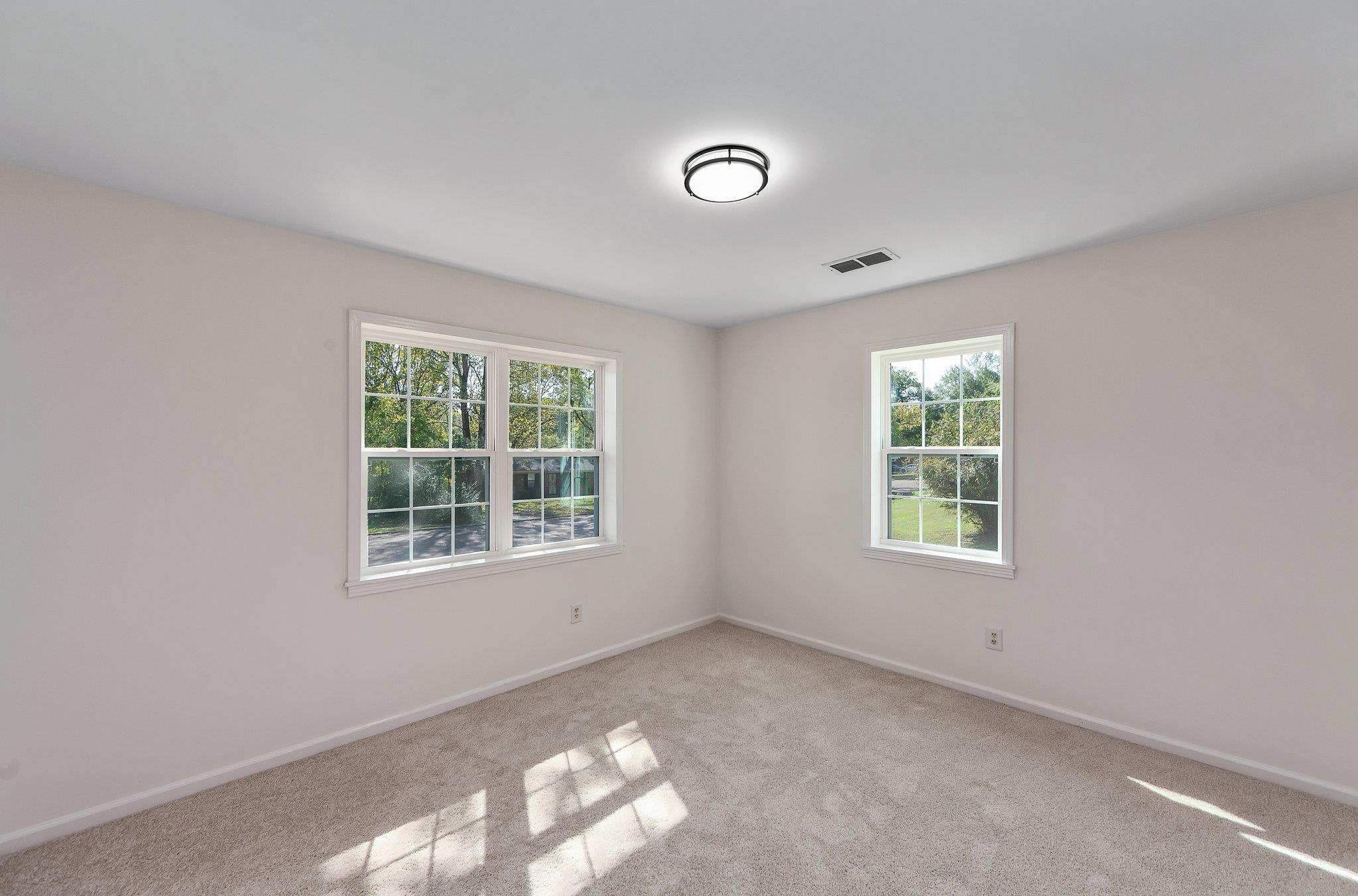 Carpeted empty room with plenty of natural light