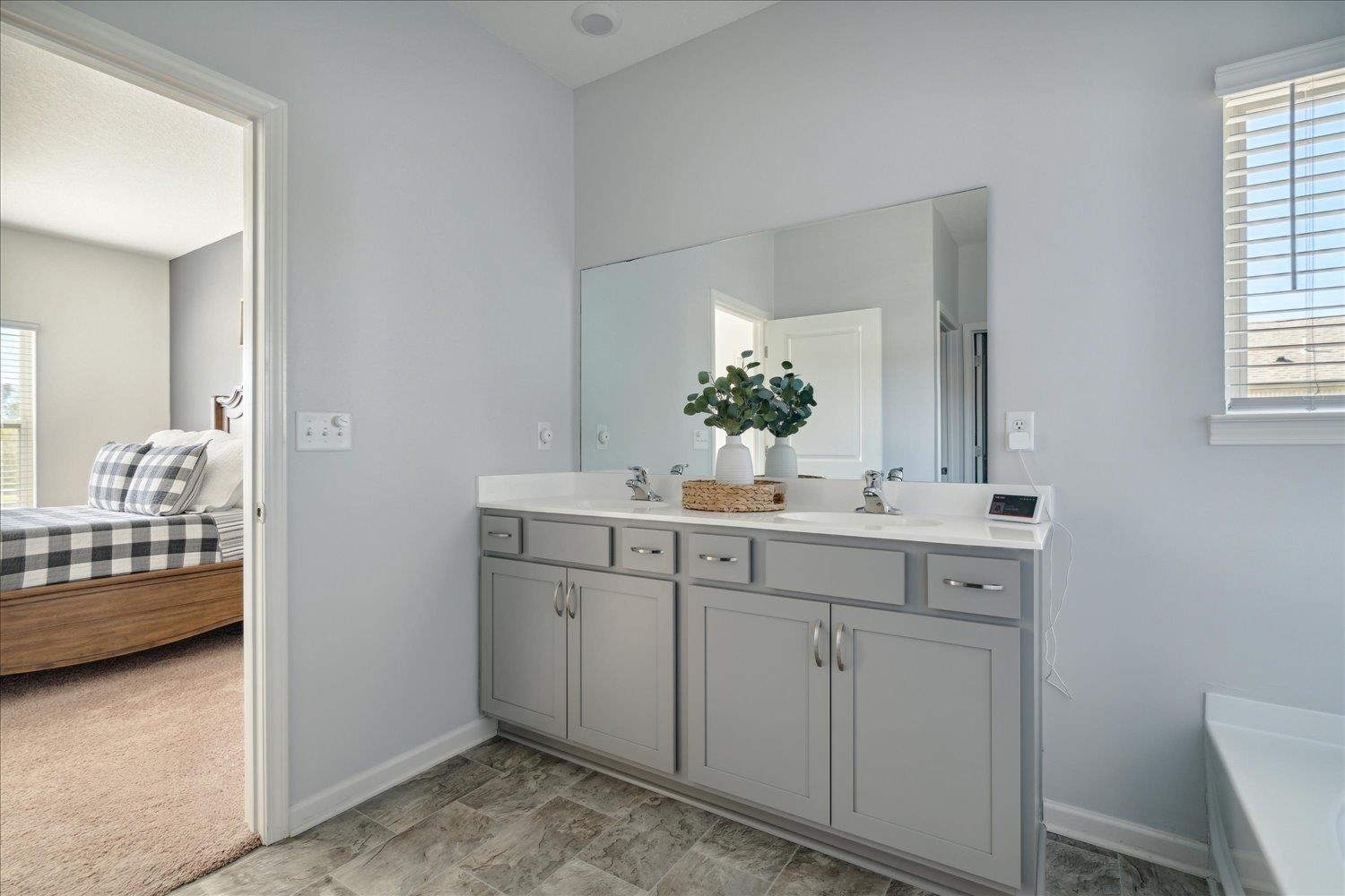 Bathroom with vanity and a tub to relax in