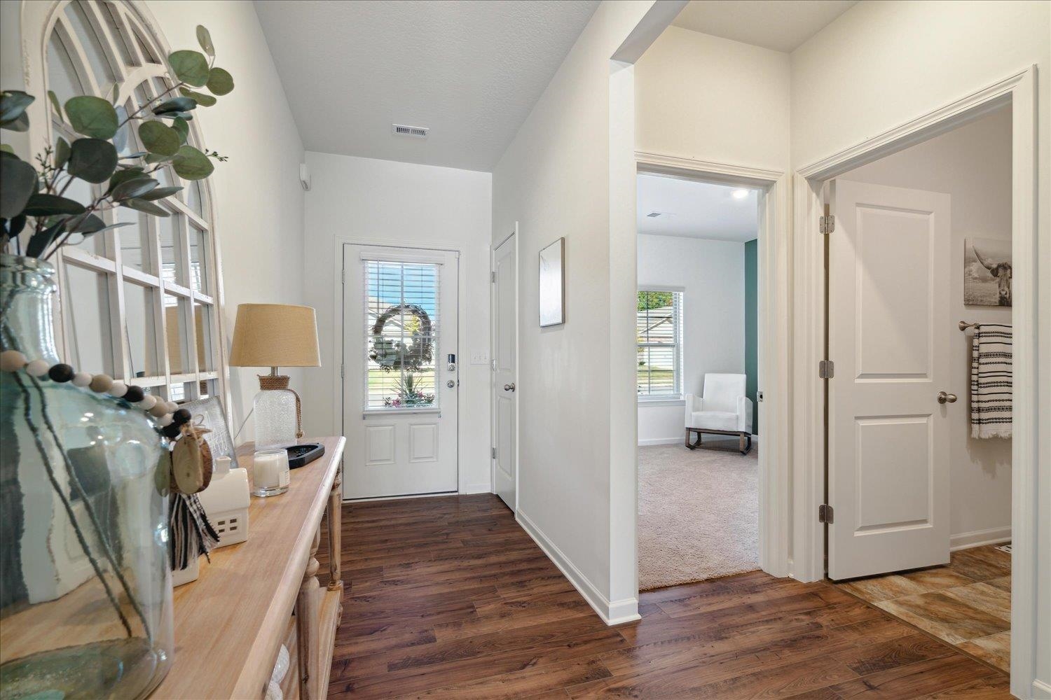 Entrance foyer featuring a wealth of natural light and dark hardwood / wood-style flooring