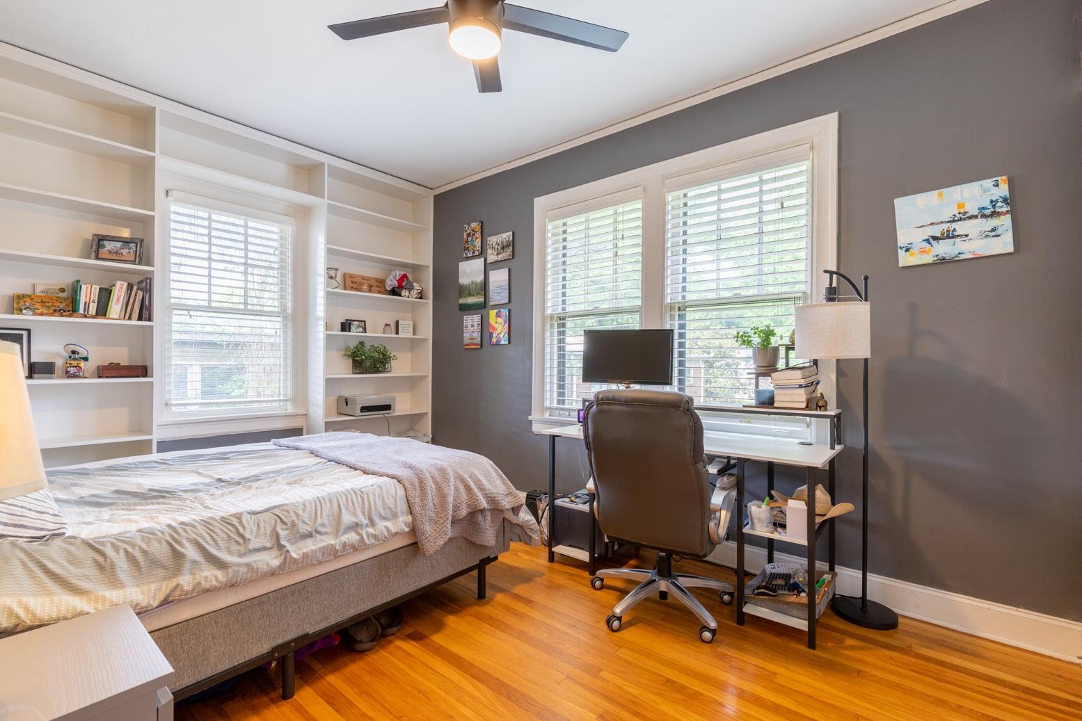 Bedroom with light hardwood / wood-style floors, multiple windows, crown molding, and ceiling fan