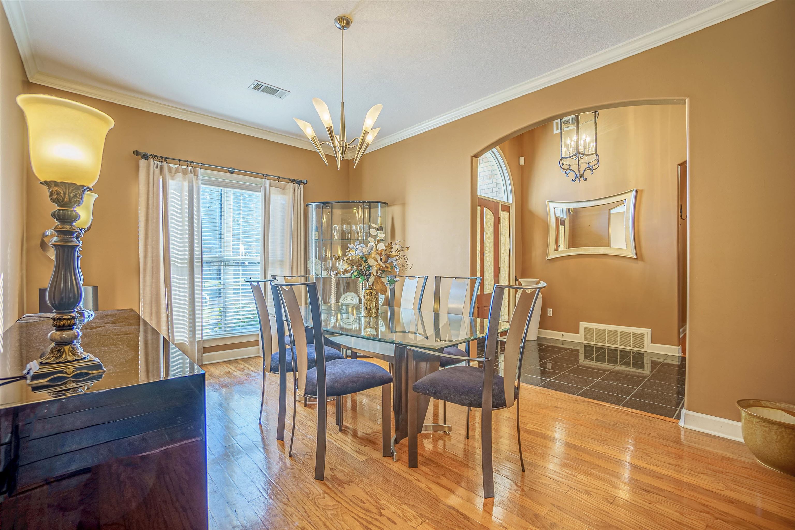 Dining area featuring ornamental molding, a chandelier, and hardwood / wood-style floors