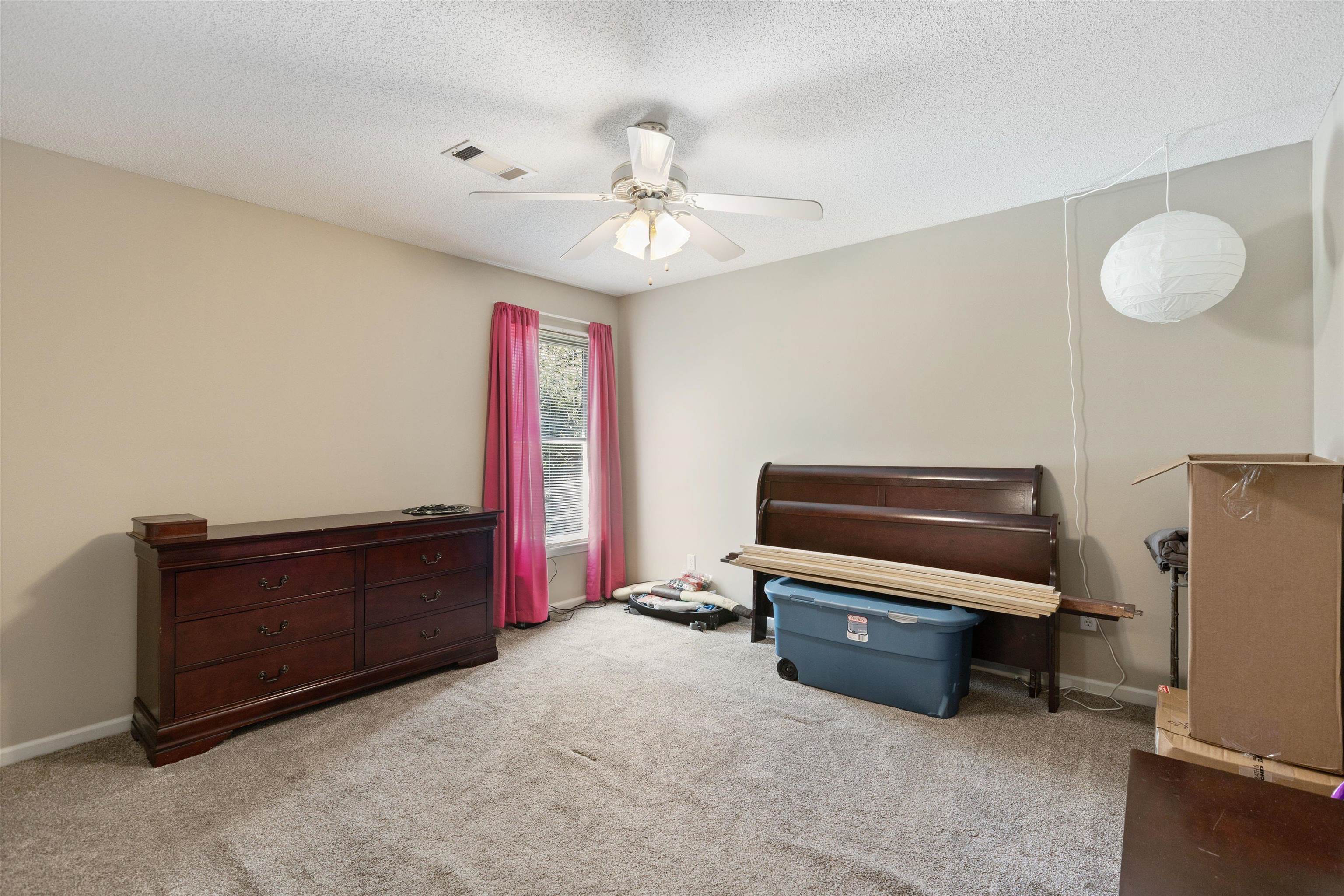 Misc room with light carpet, a textured ceiling, and ceiling fan