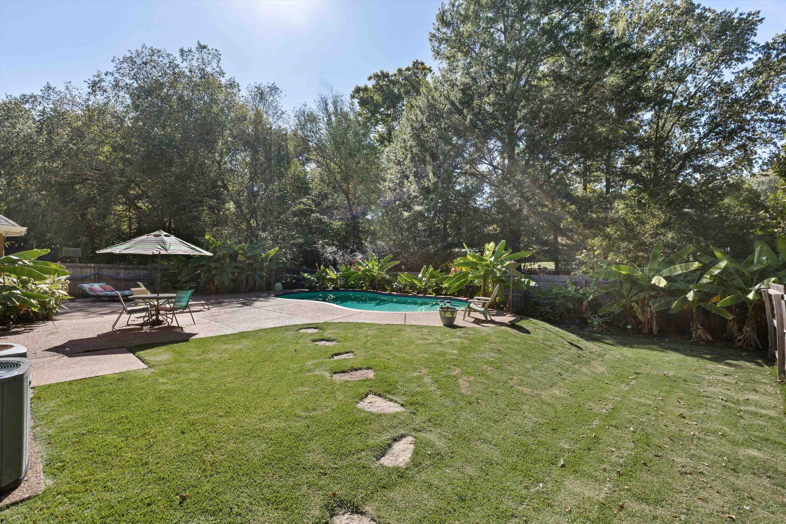 View of yard featuring a patio and a fenced in pool
