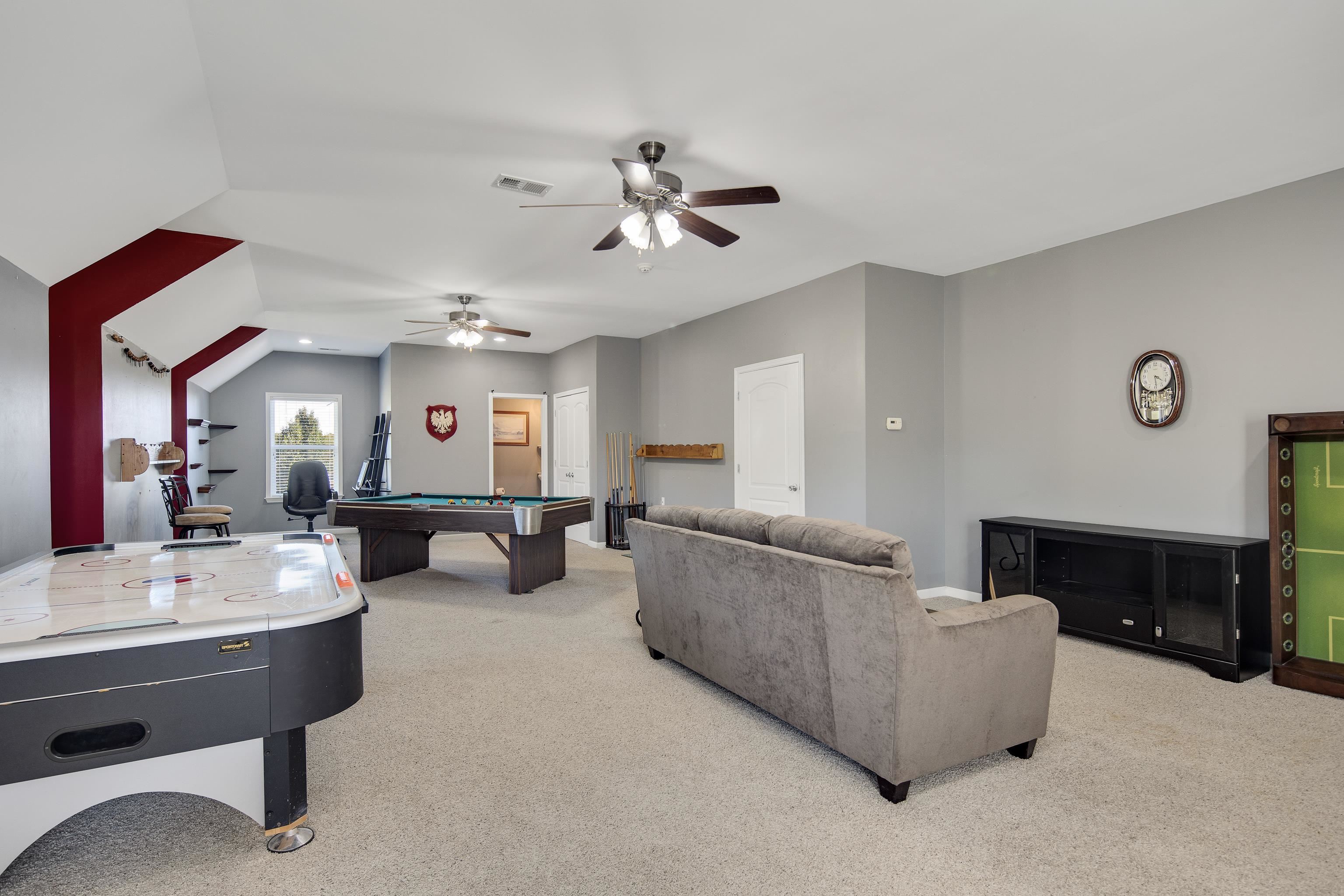 Rec room featuring pool table, vaulted ceiling, light carpet, and ceiling fan