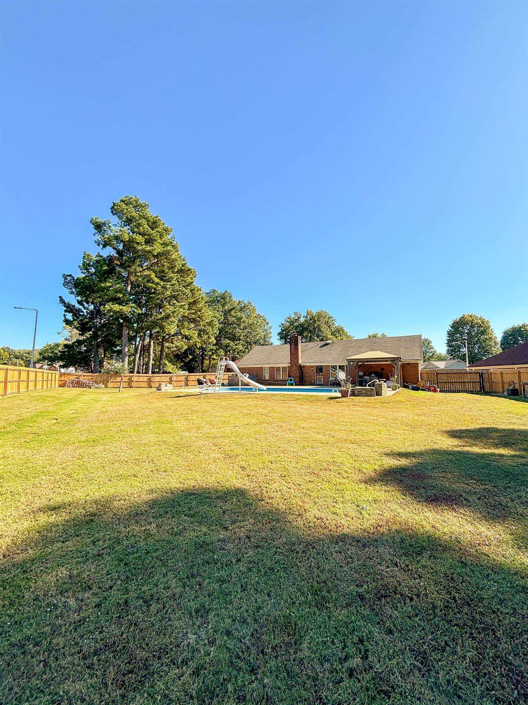 View of yard with a fenced in pool