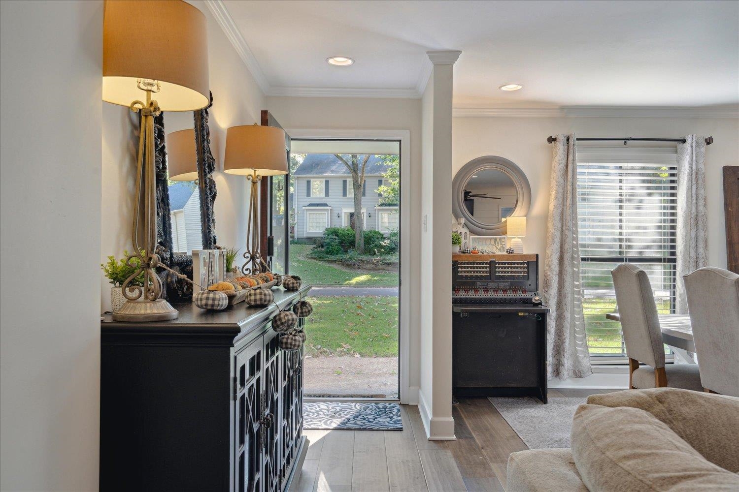 Entrance foyer with ornamental molding and hardwood / wood-style floors