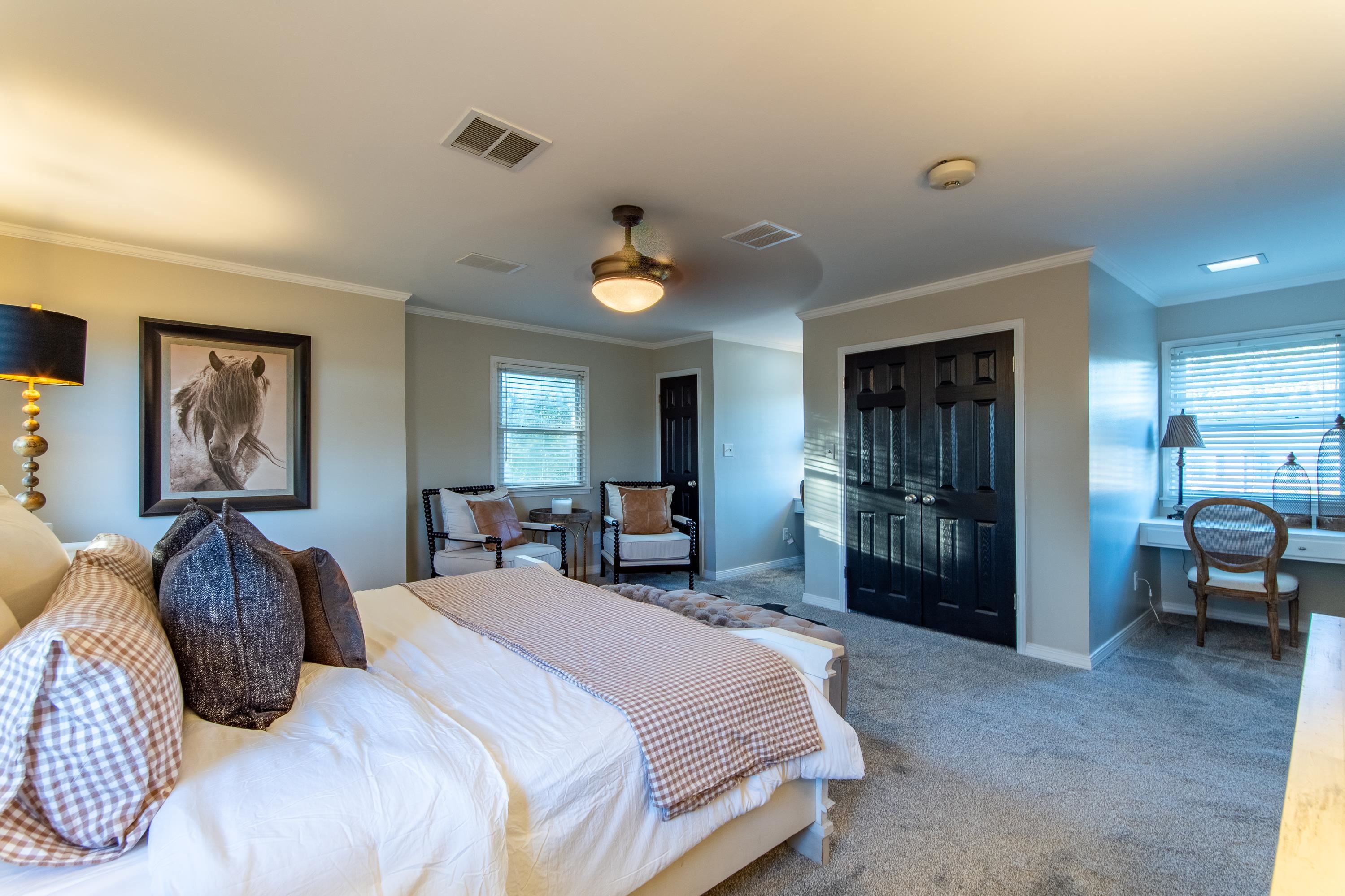 Carpeted bedroom with crown molding, a closet, and ceiling fan