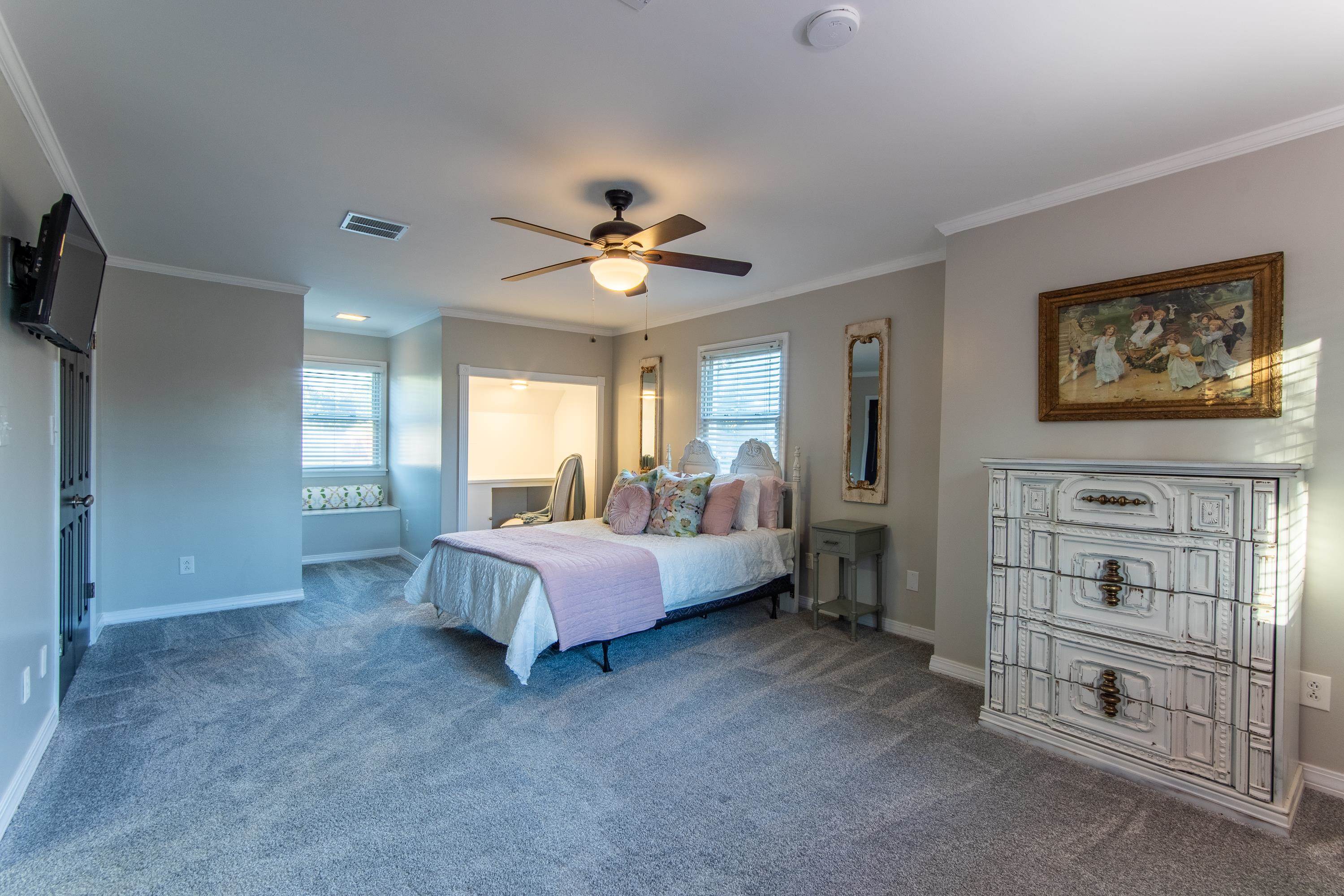 Bedroom featuring ornamental molding, carpet flooring, and ceiling fan