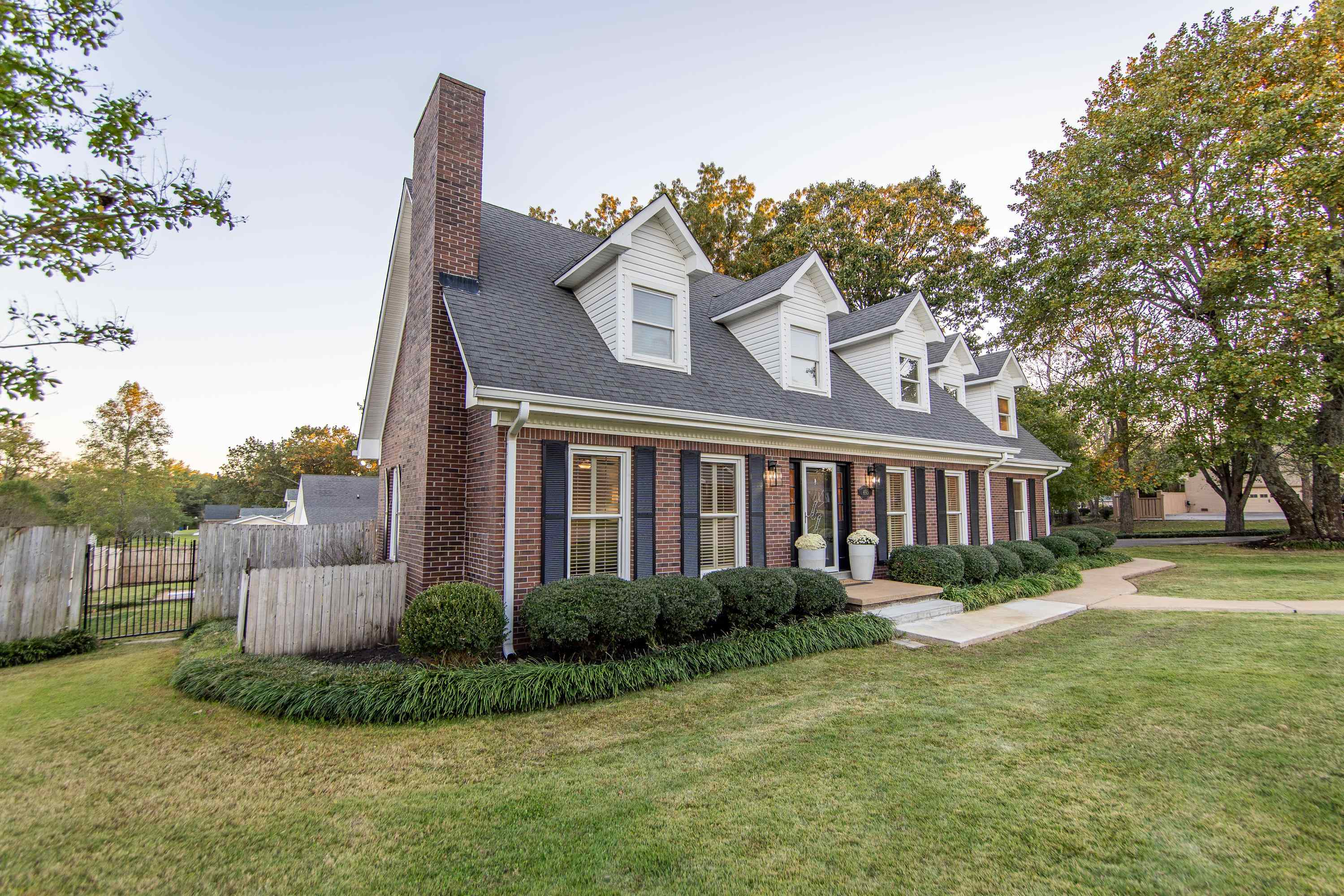 Cape cod home with a front lawn