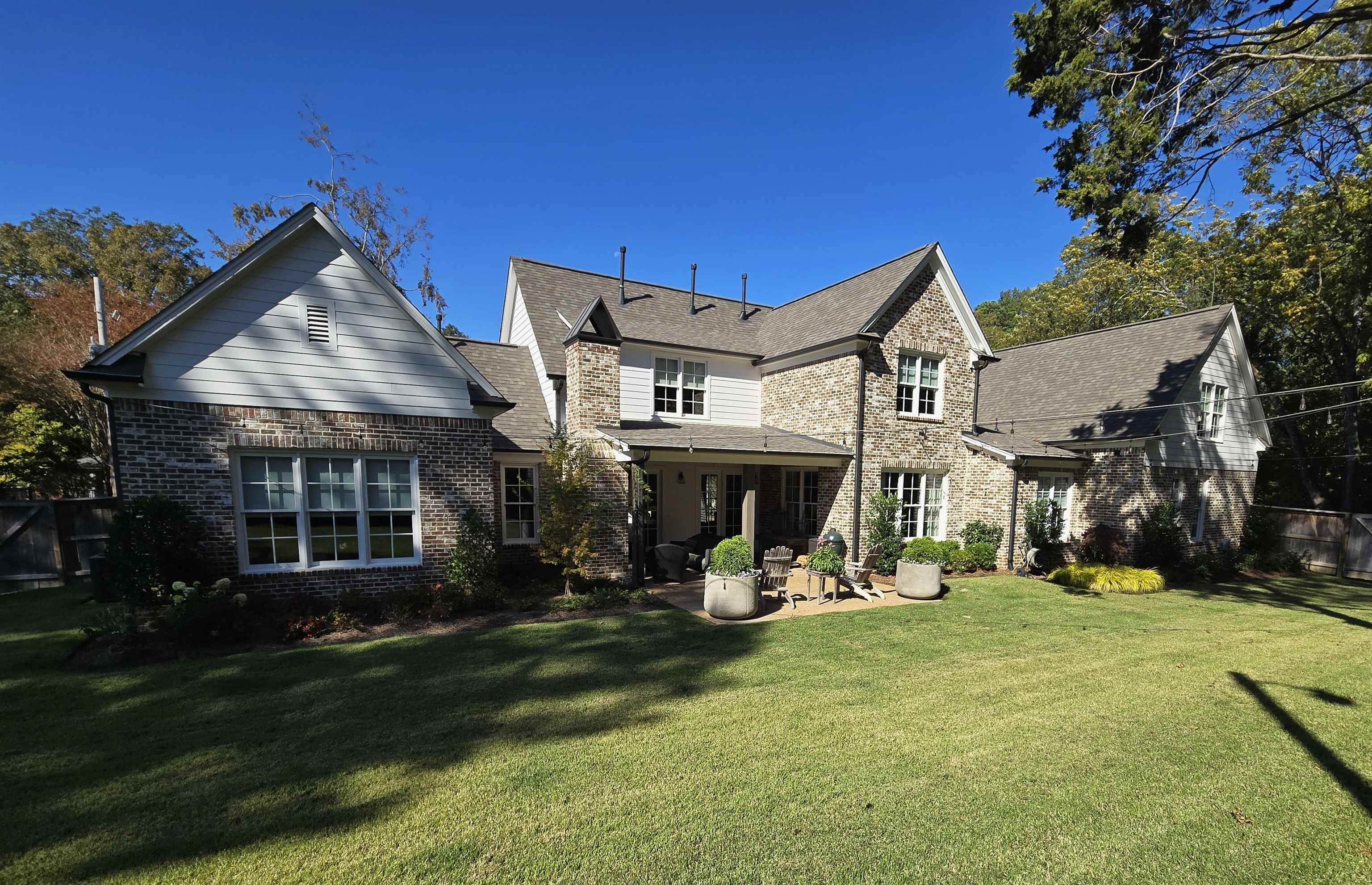 Rear view of house featuring a yard and a patio