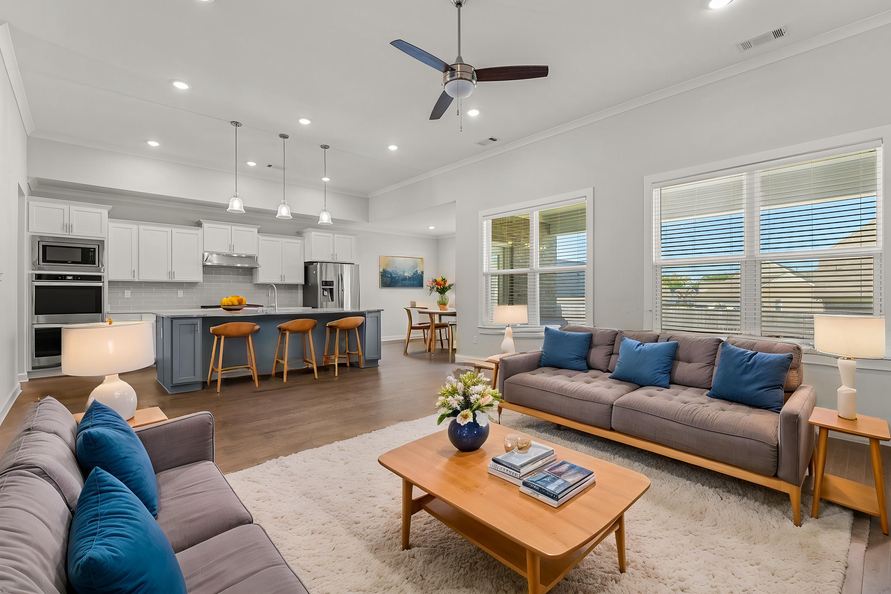 Living room featuring ornamental molding, wood-type flooring, and ceiling fan