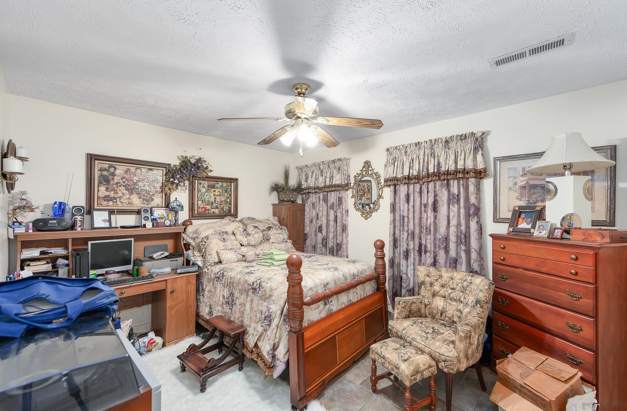 Bedroom featuring a textured ceiling and ceiling fan