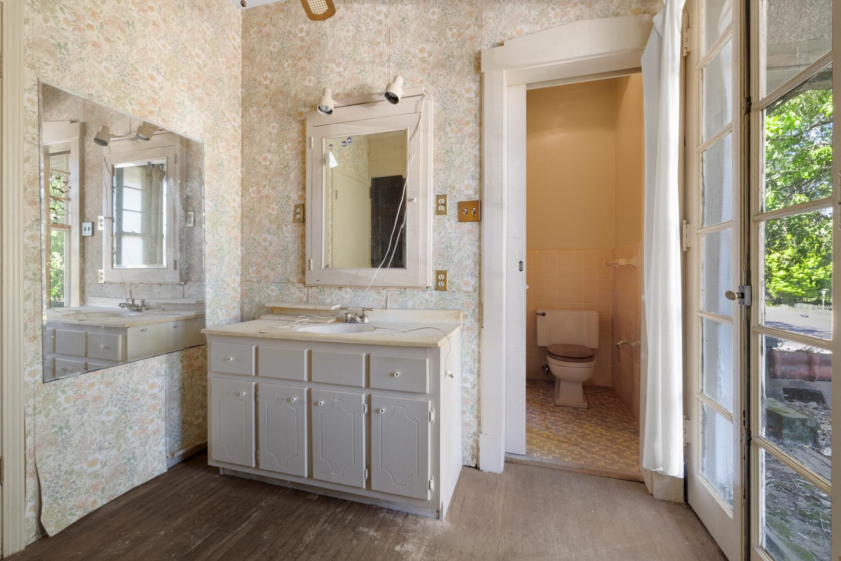 Bathroom with vanity, hardwood / wood-style flooring, toilet, and tile walls