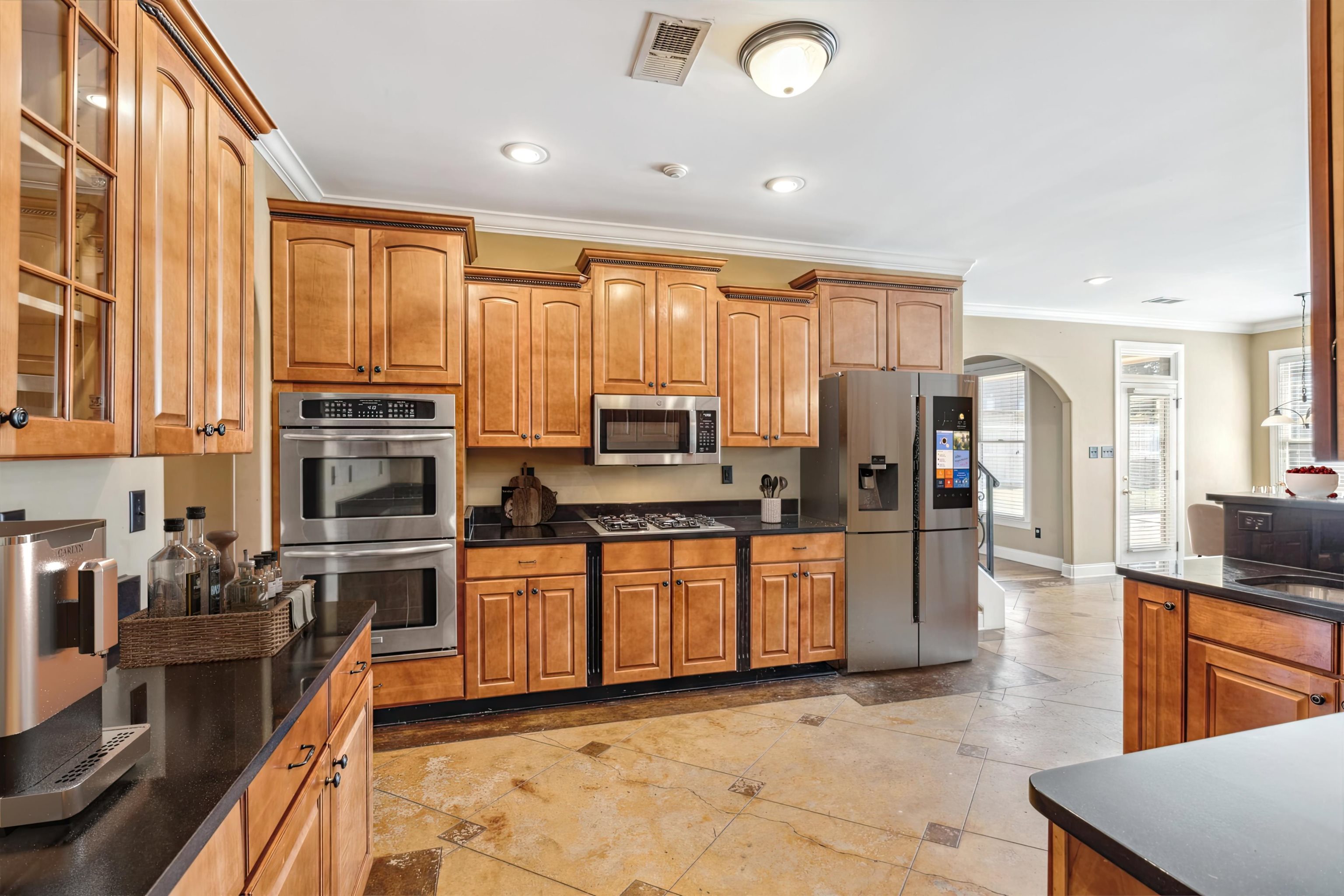 Kitchen with appliances with stainless steel finishes and ornamental molding