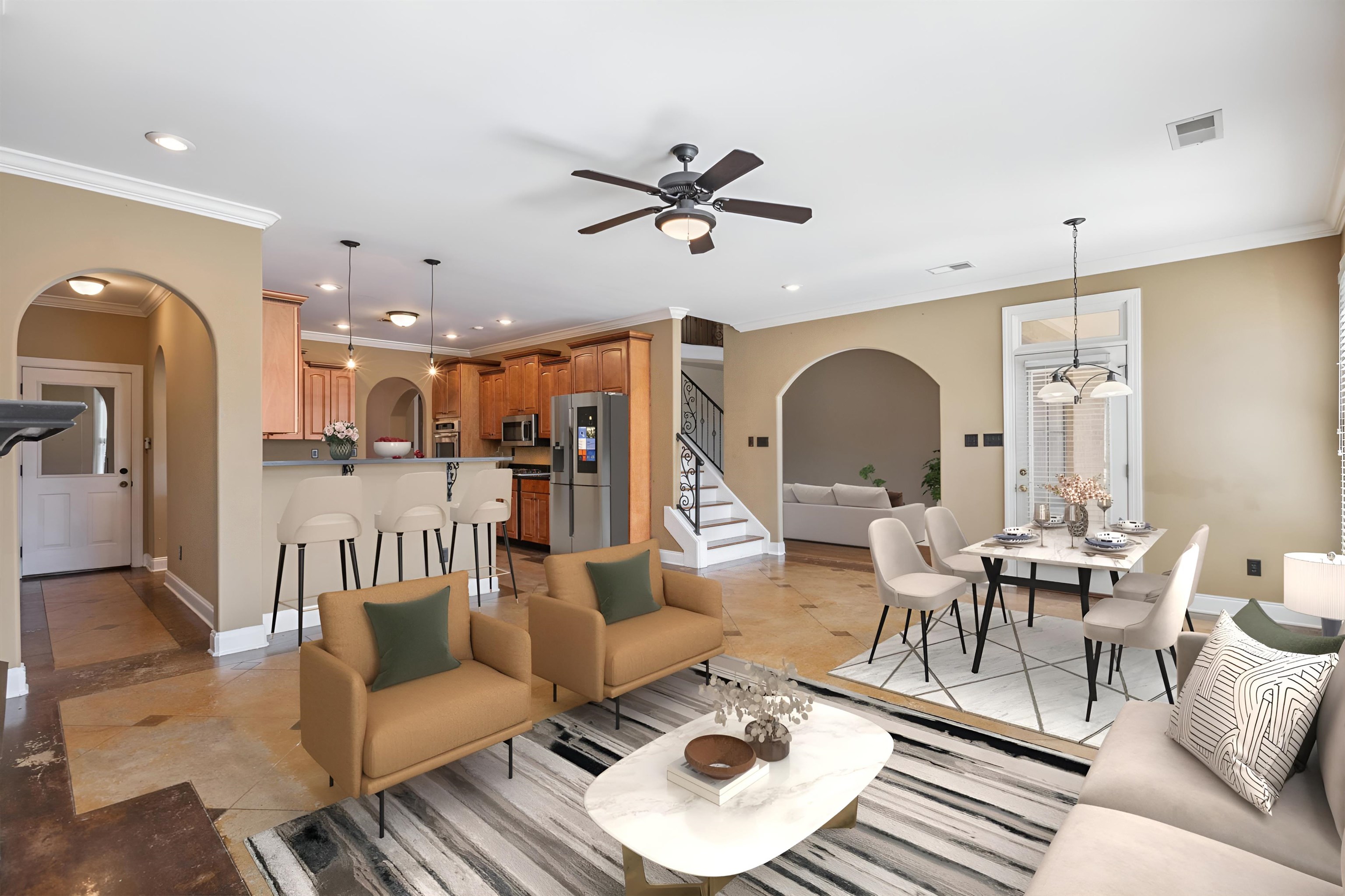 Tiled living room featuring ceiling fan and ornamental molding