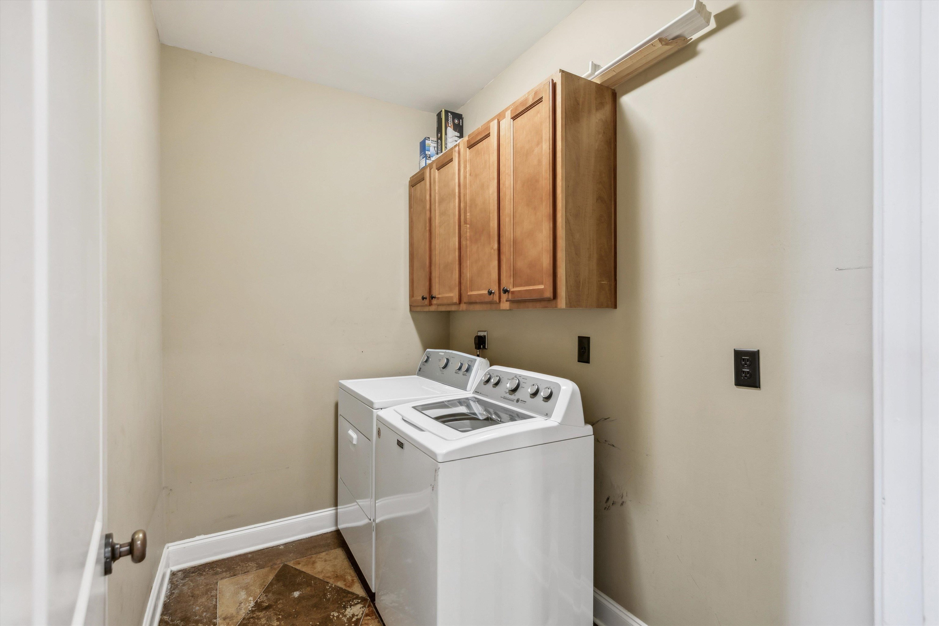 Laundry area featuring cabinets and washer and dryer