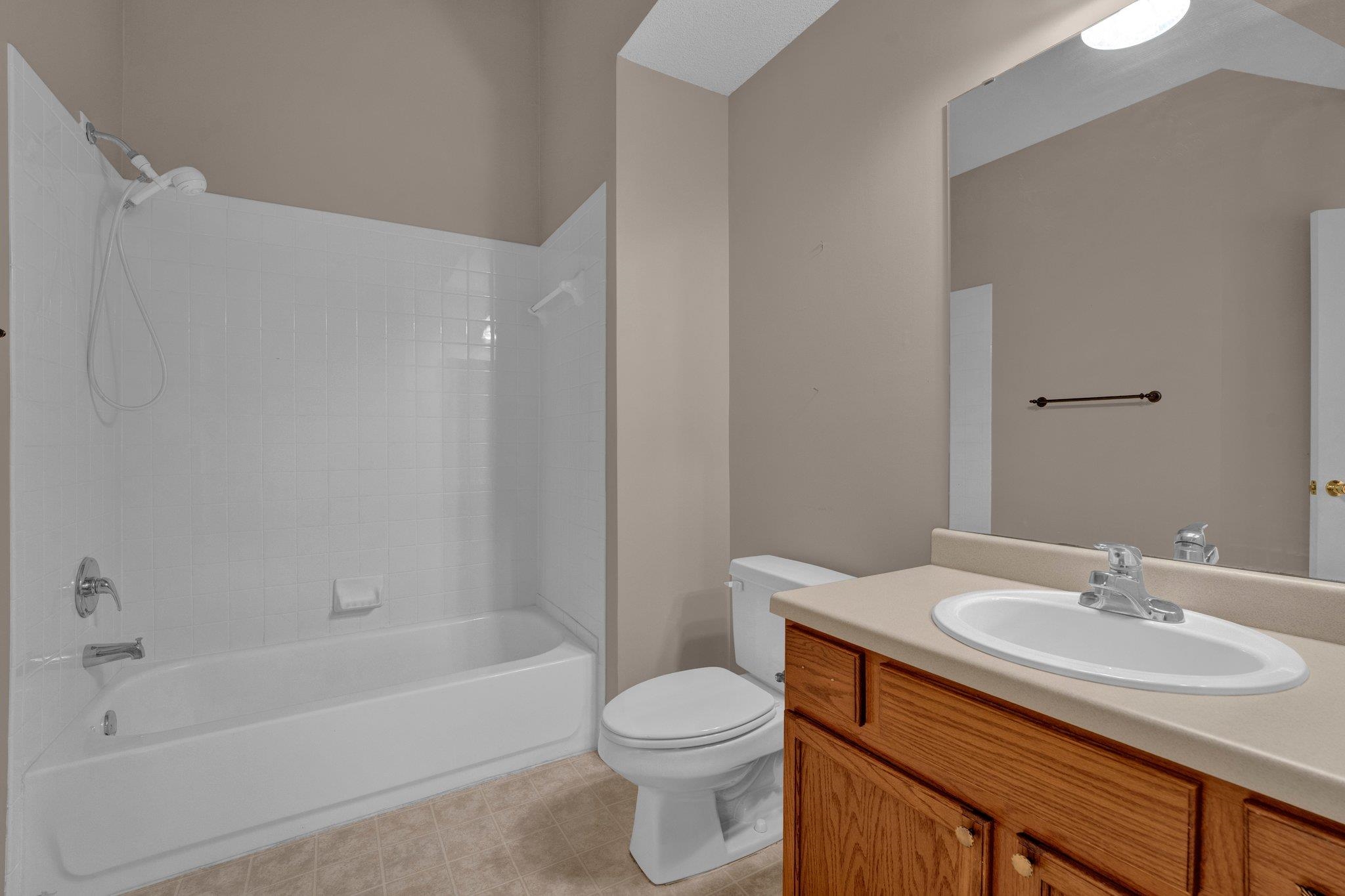 Full bathroom featuring toilet, vanity, and shower / bathtub combination