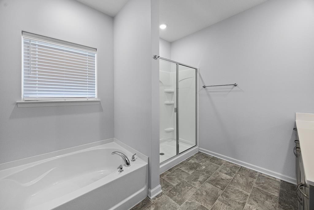 Bathroom with vanity and plus walk in shower