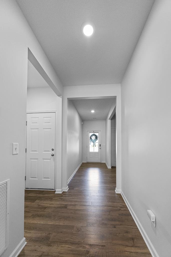 Corridor with dark wood-type flooring