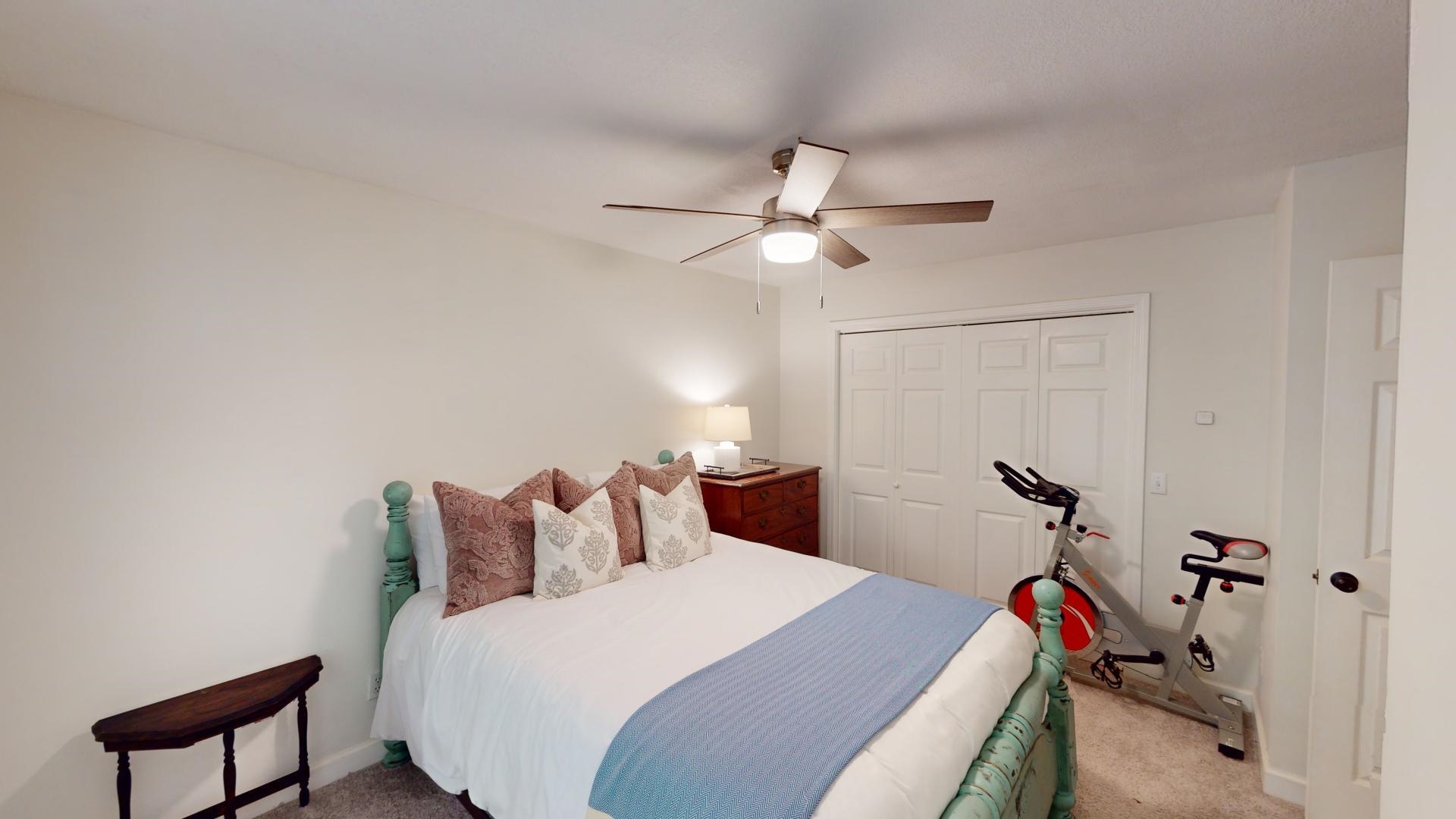 Bedroom with carpet floors, a closet, and ceiling fan